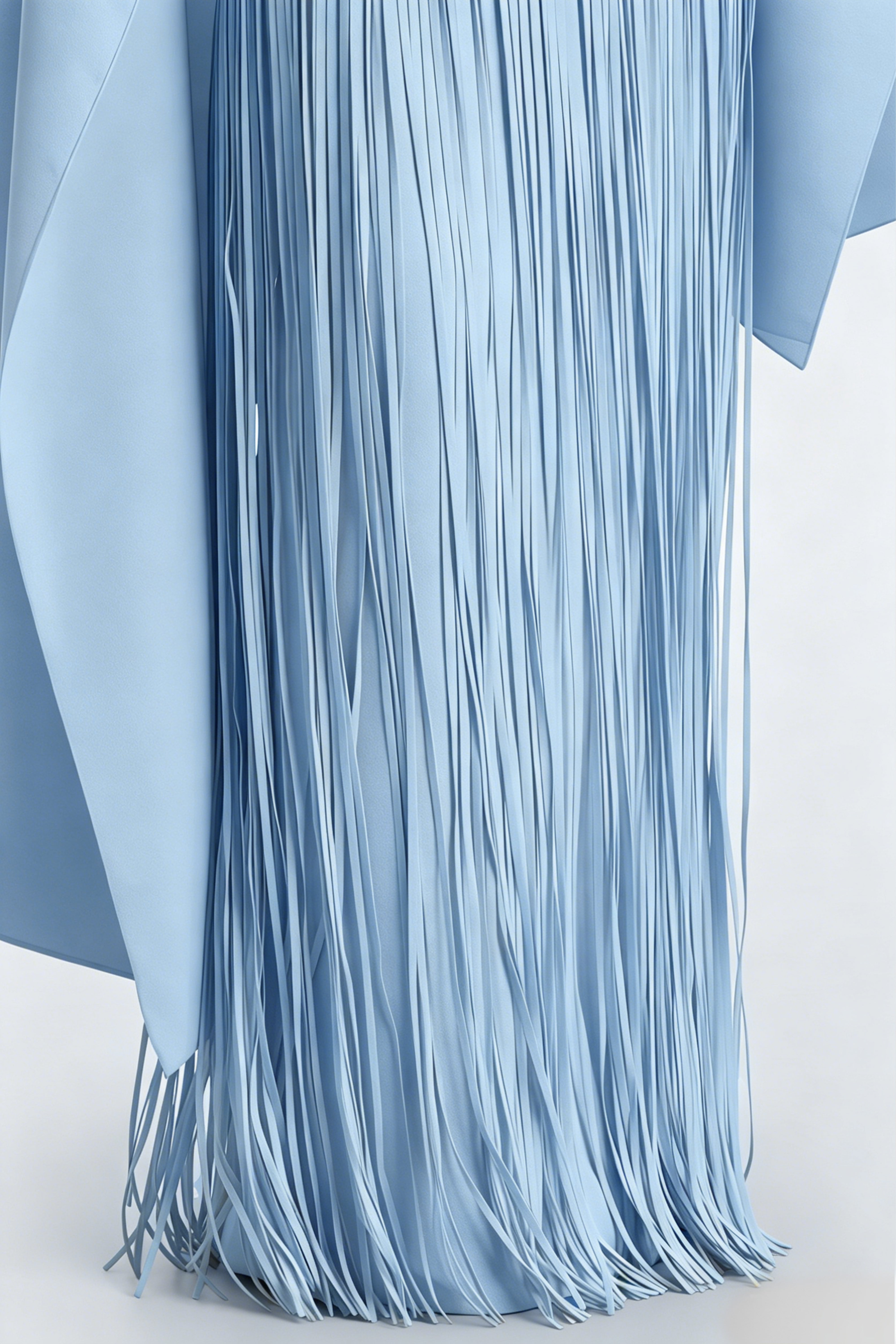 Light blue cape-style gown with a long fringed skirt