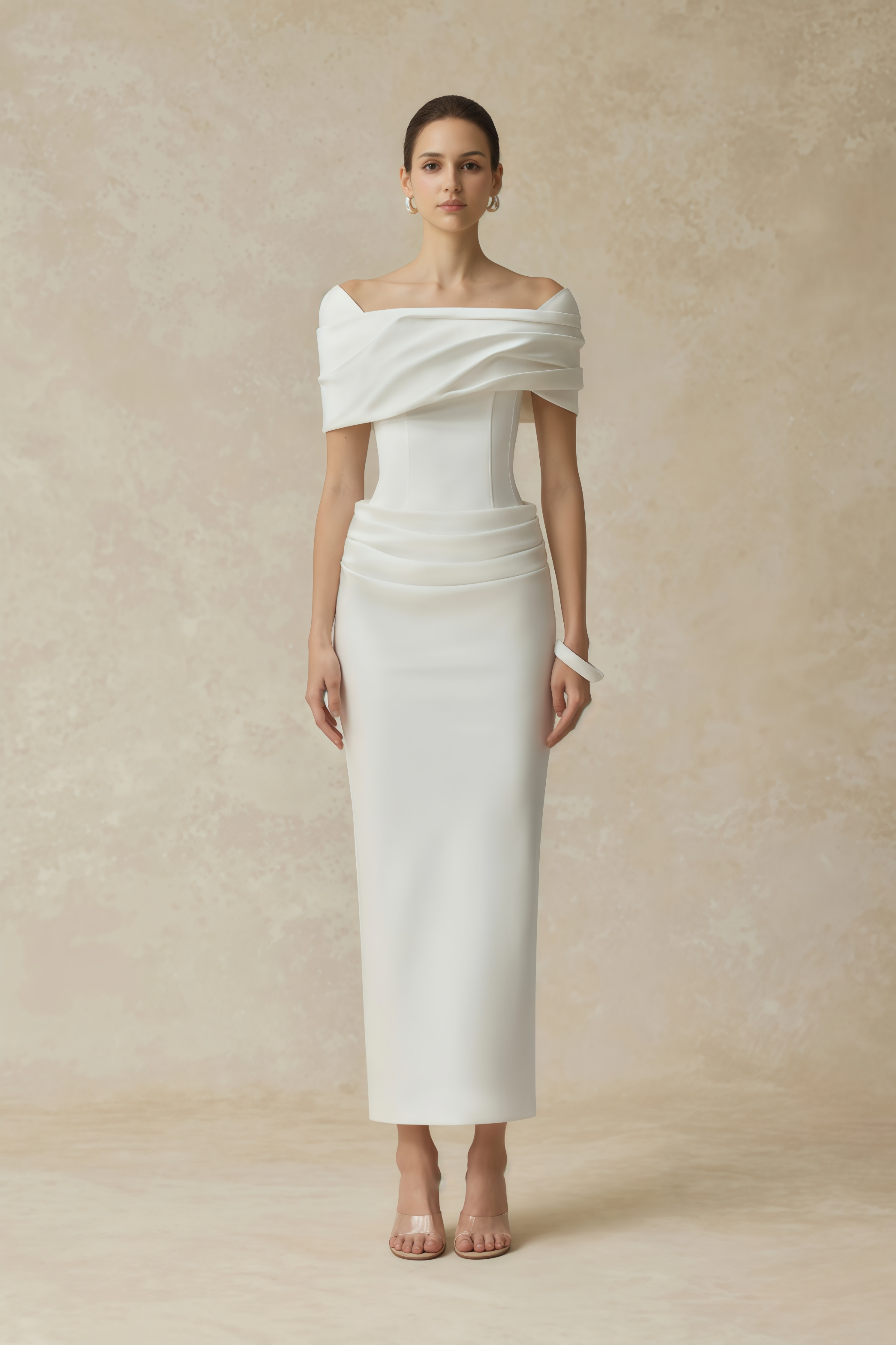 White off-the-shoulder gown with a draped bodice and cascading side ruffles