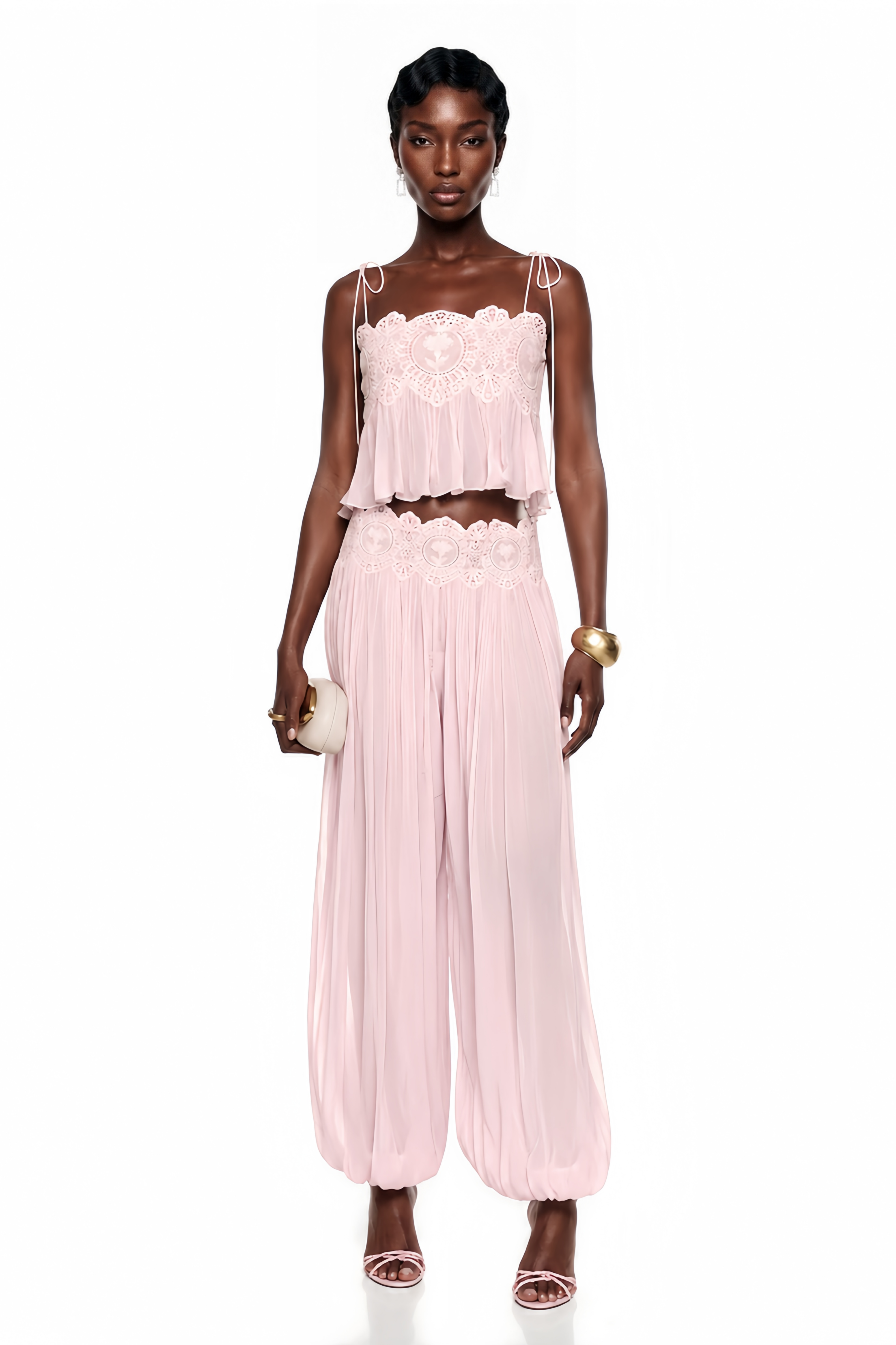 Light pink pleated two-piece set featuring a lace-trimmed camisole crop top and matching wide-leg harem pants