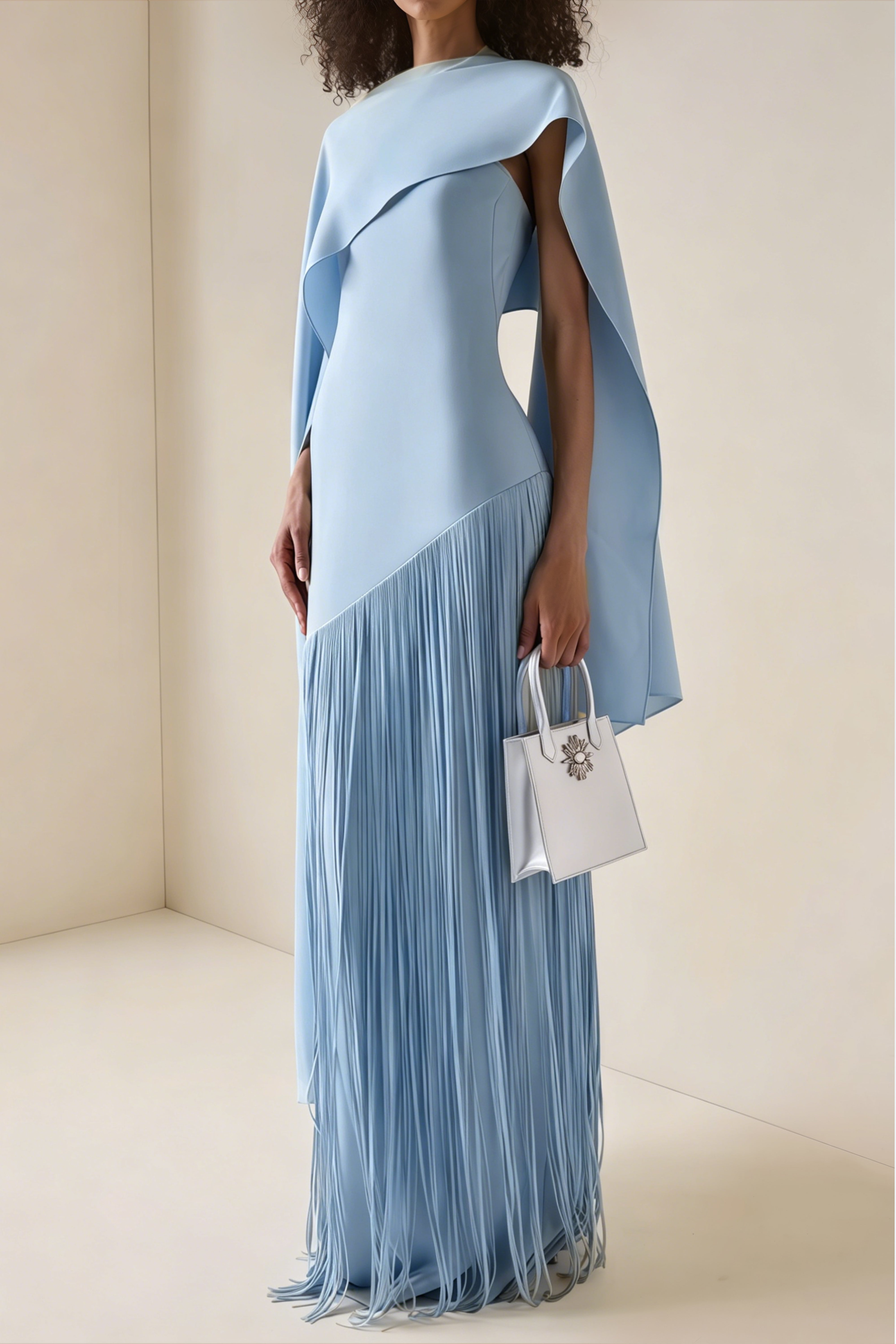 Light blue cape-style gown with a long fringed skirt