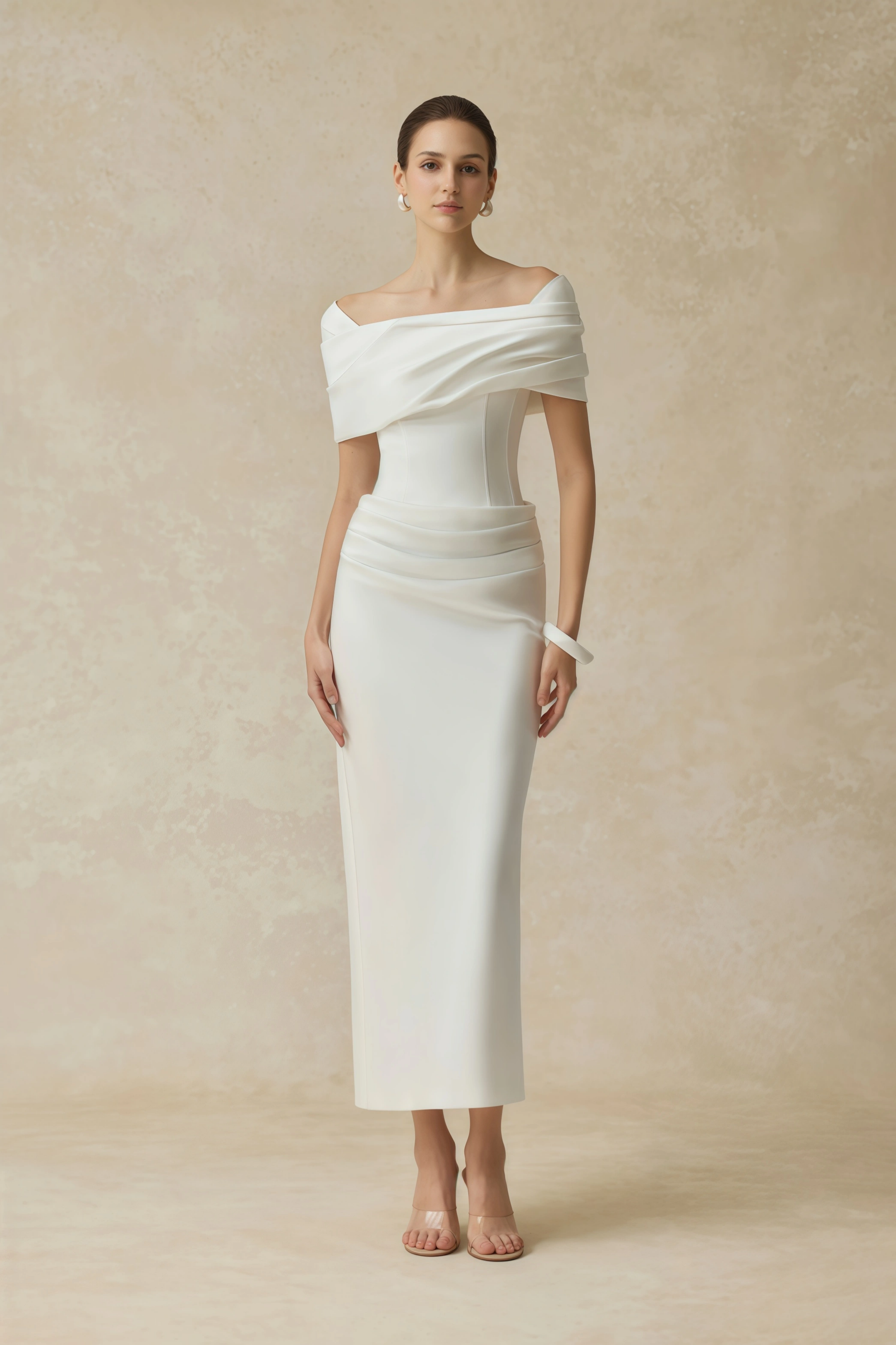 White off-the-shoulder gown with a draped bodice and cascading side ruffles