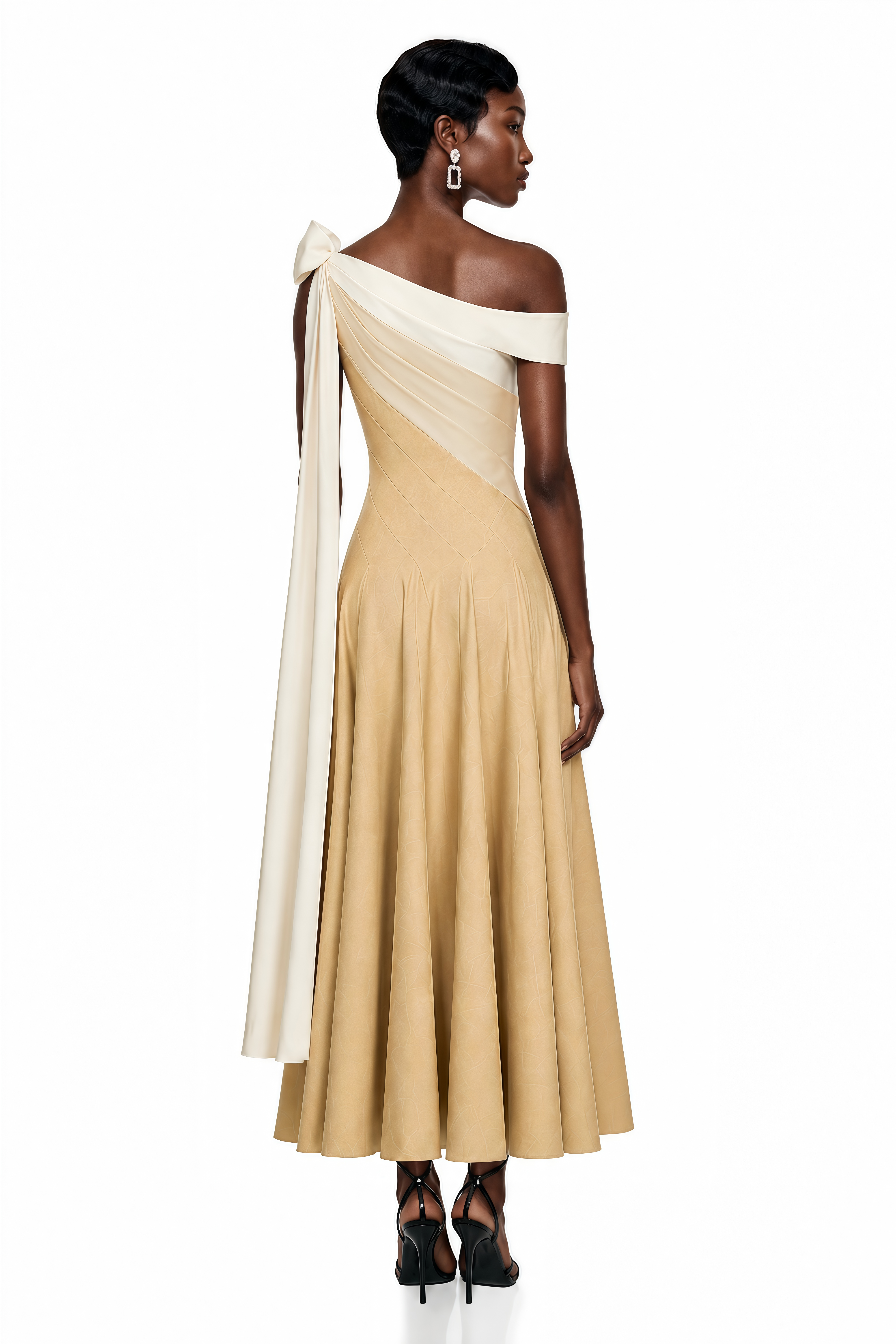 Beige maxi dress with a cream off-the-shoulder neckline, long trailing sash, and A-line skirt