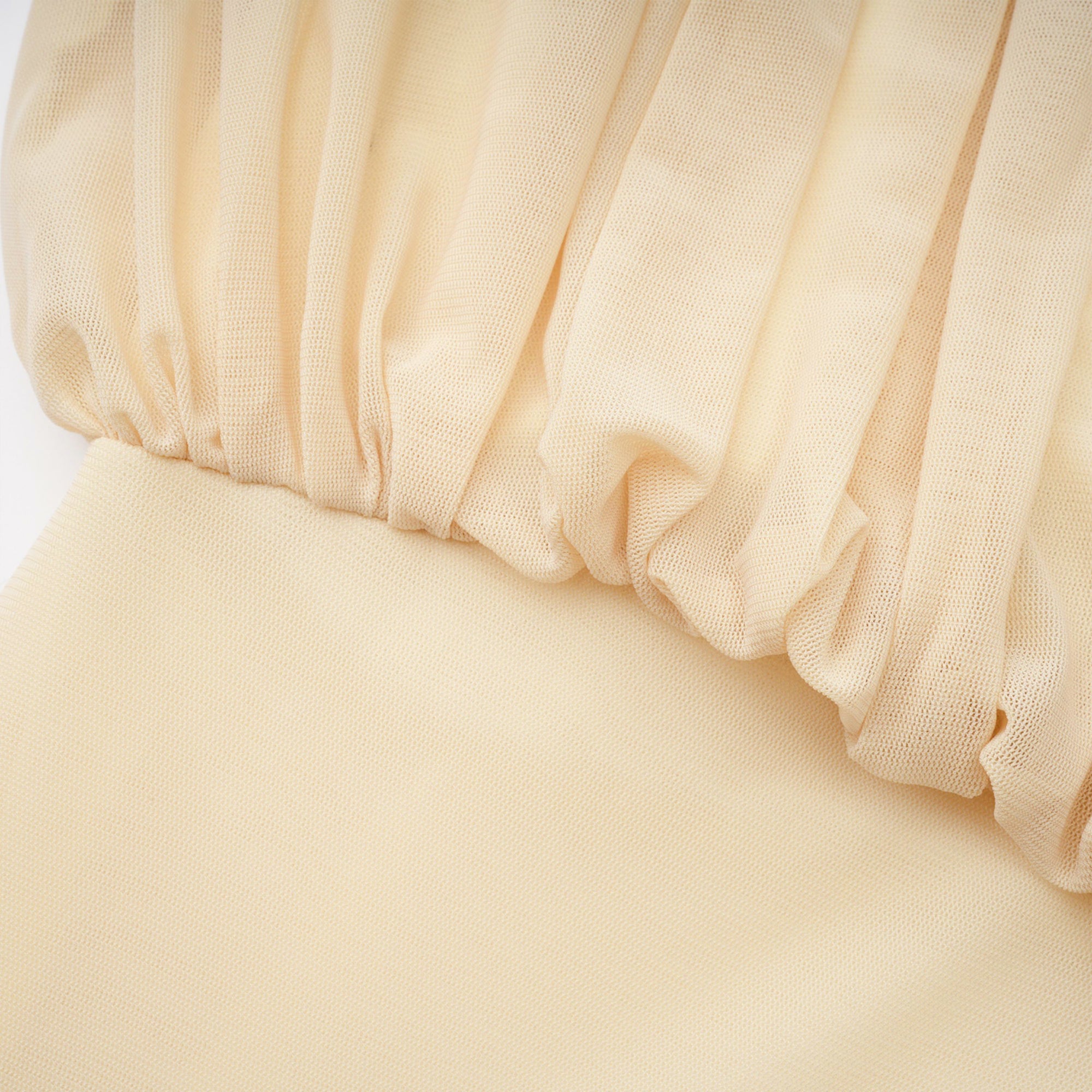 Pale yellow maxi dress with a ruched bodice, high round neckline, and long bishop sleeves
