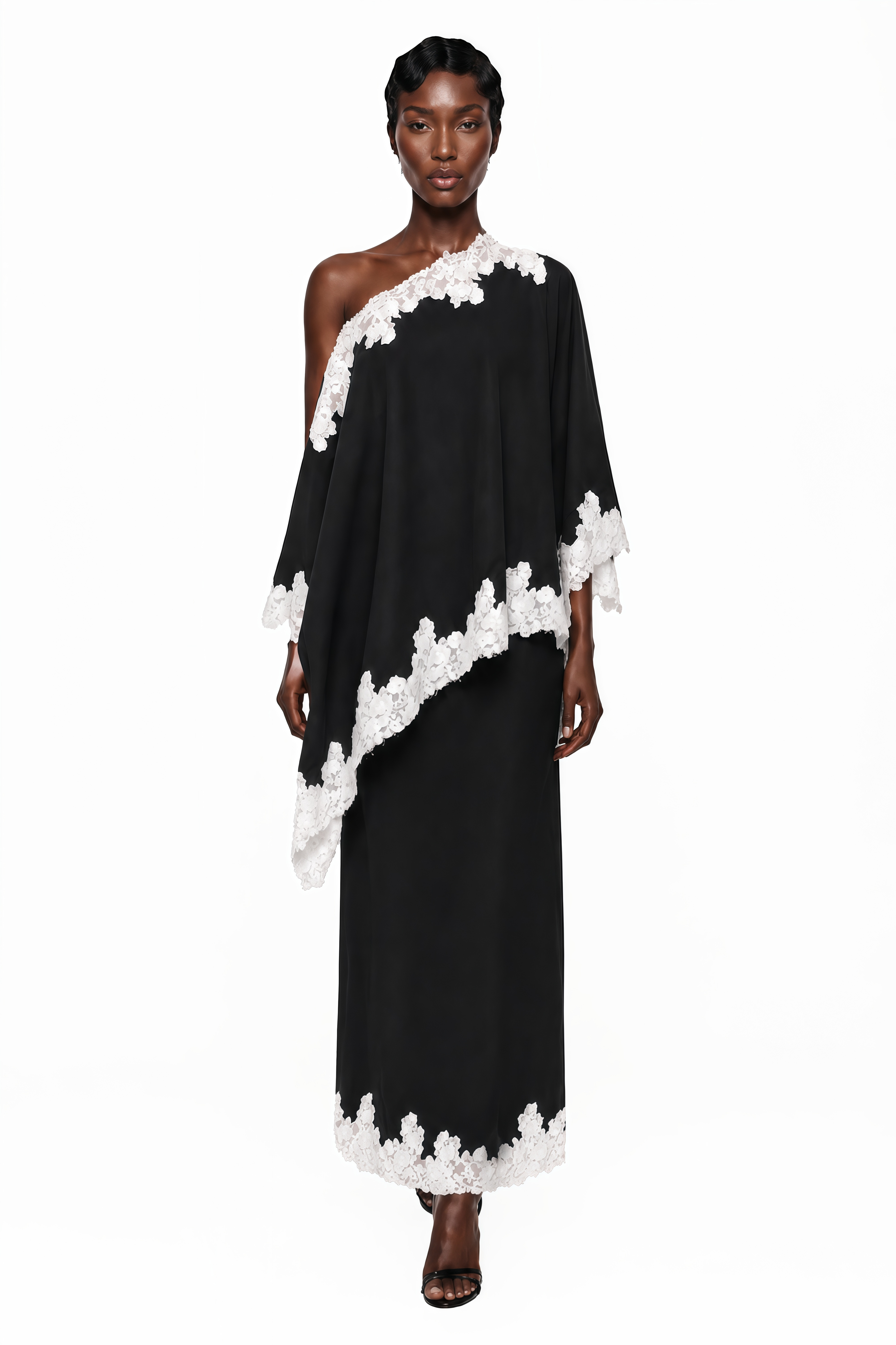 Black one-shoulder maxi dress with an asymmetric lace-trimmed cape and lace-trimmed hem