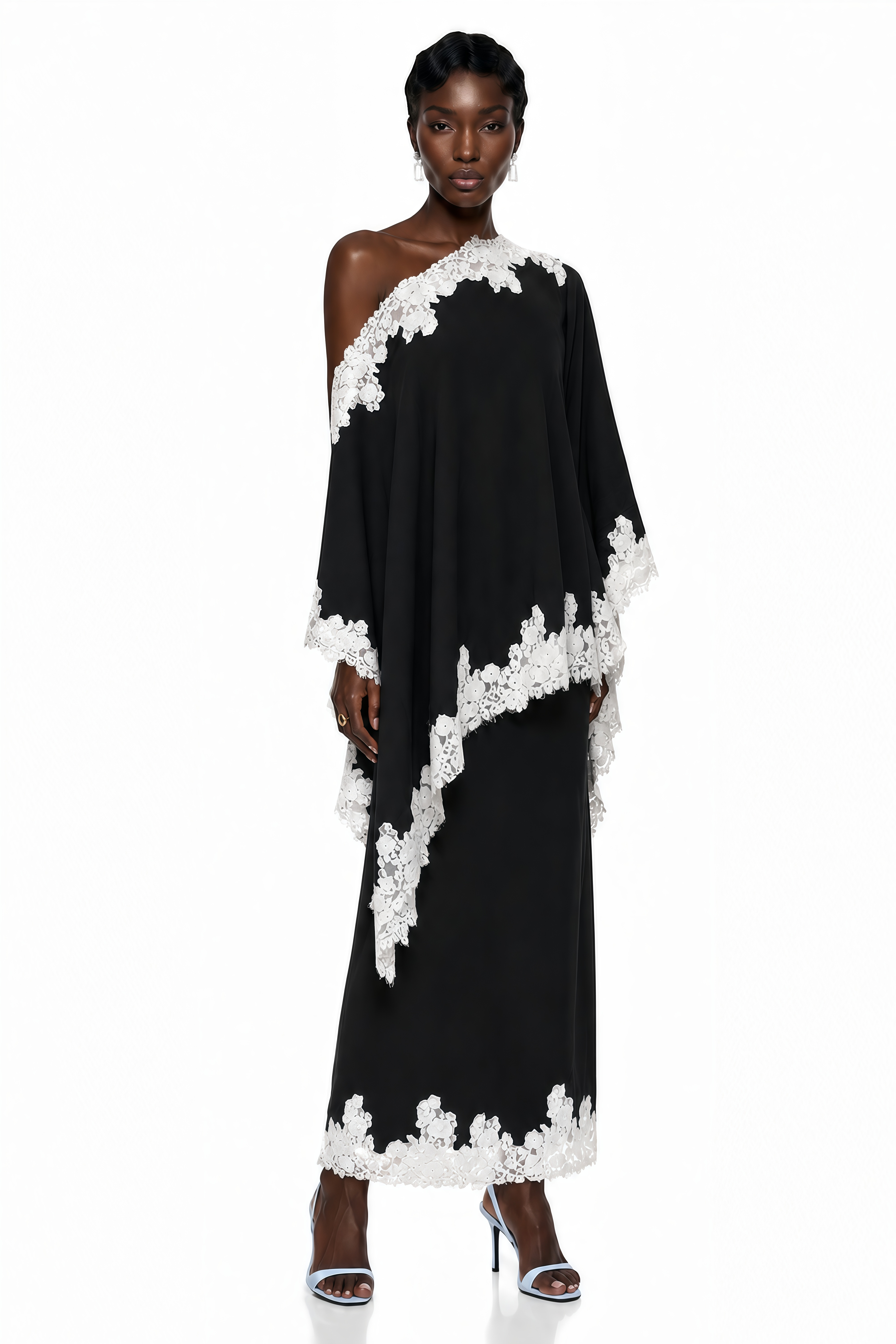 Black one-shoulder maxi dress with an asymmetric lace-trimmed cape and lace-trimmed hem