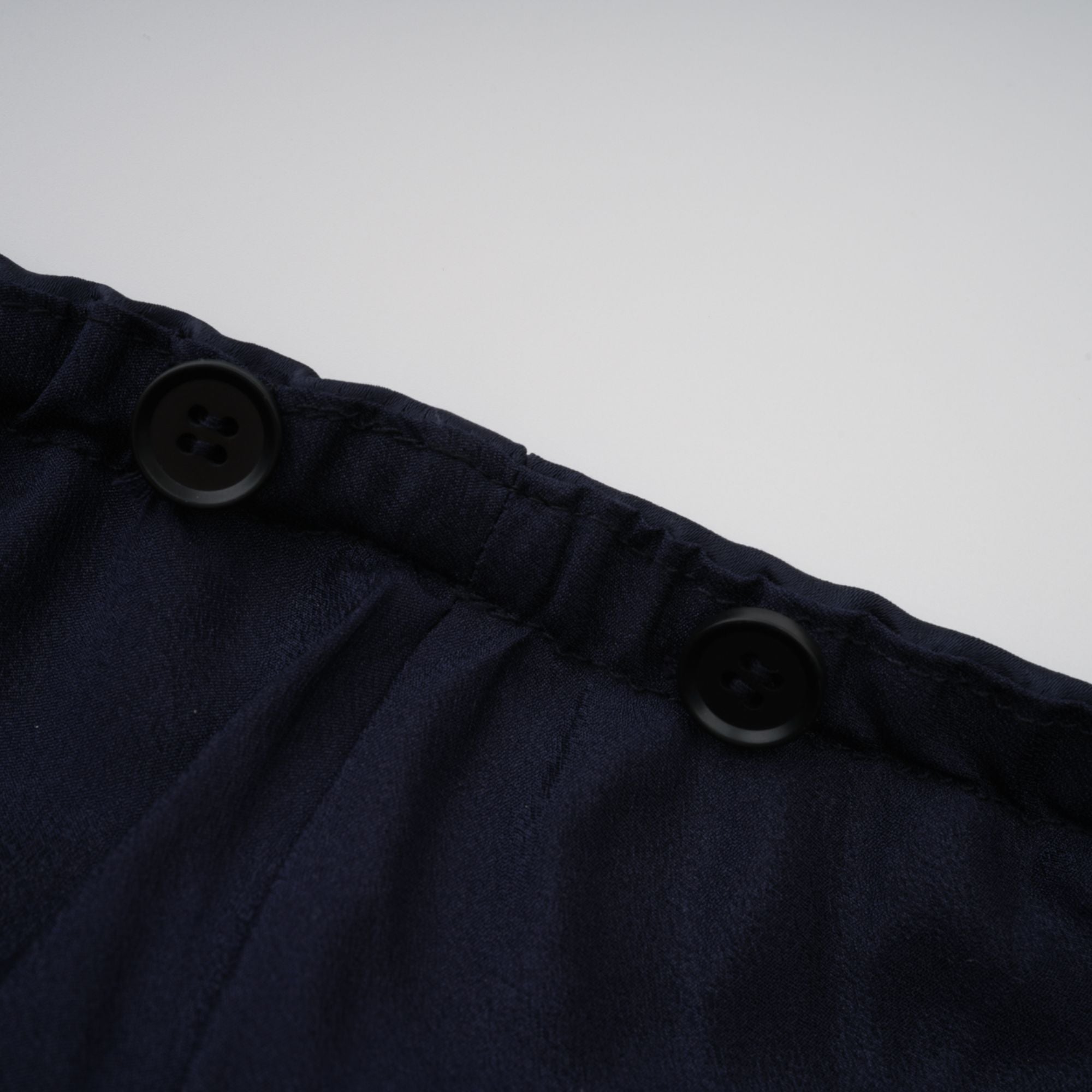 Navy blue short-sleeve maxi dress with a peplum jacket bodice and satin skirt