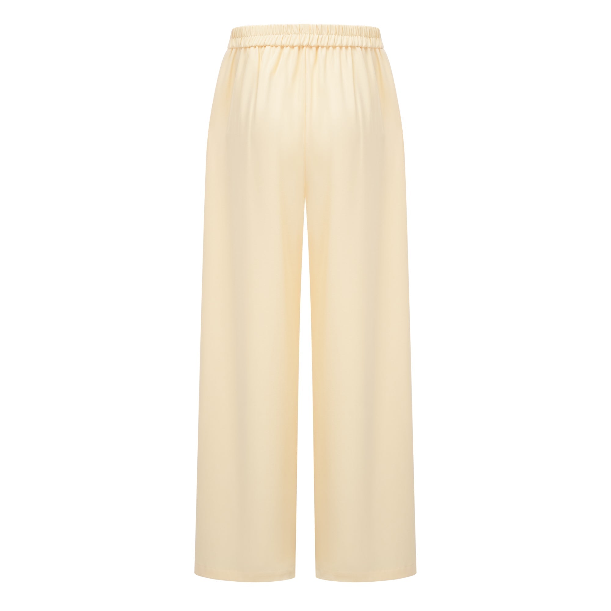 Pale yellow top and trousers set with an asymmetric blazer bodice, draped sheer neckline, and cape panels