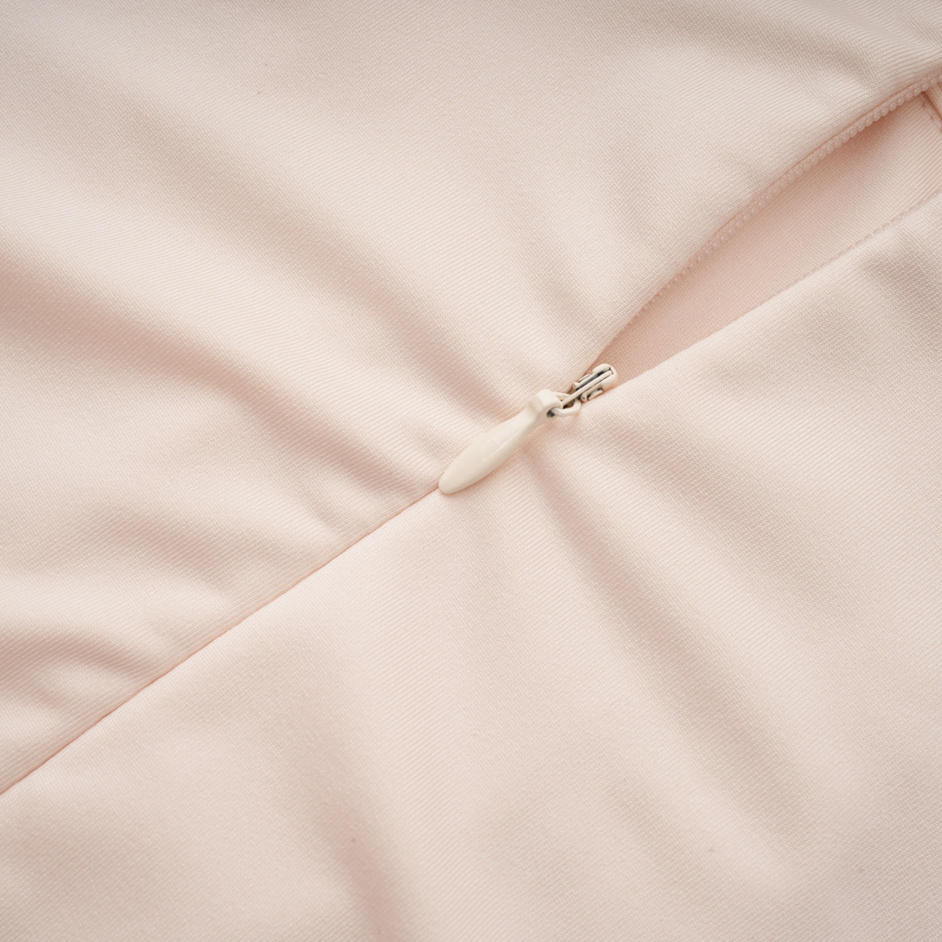 Cream halter maxi dress with waist cutouts and a knotted draped bodice