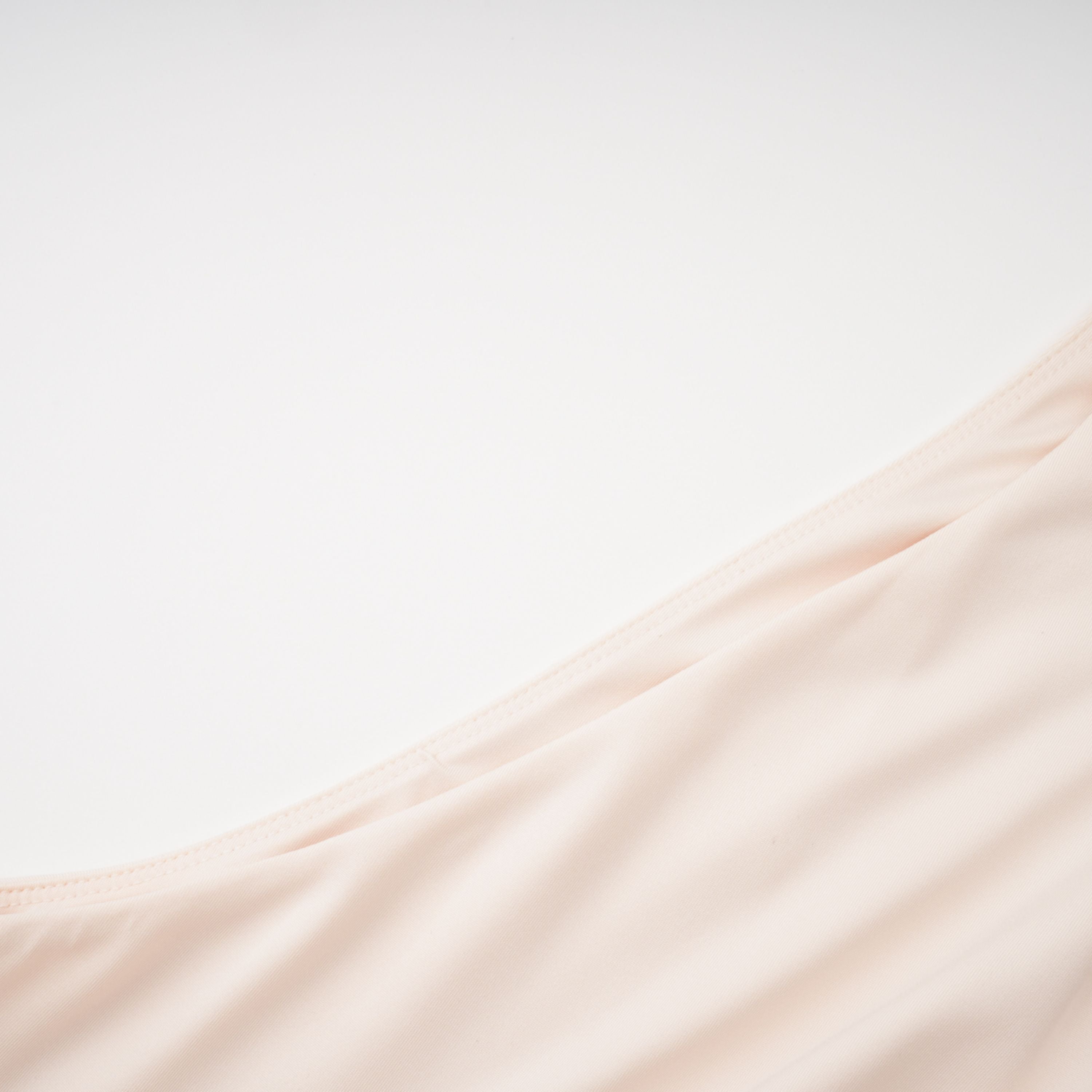 Cream halter maxi dress with waist cutouts and a knotted draped bodice