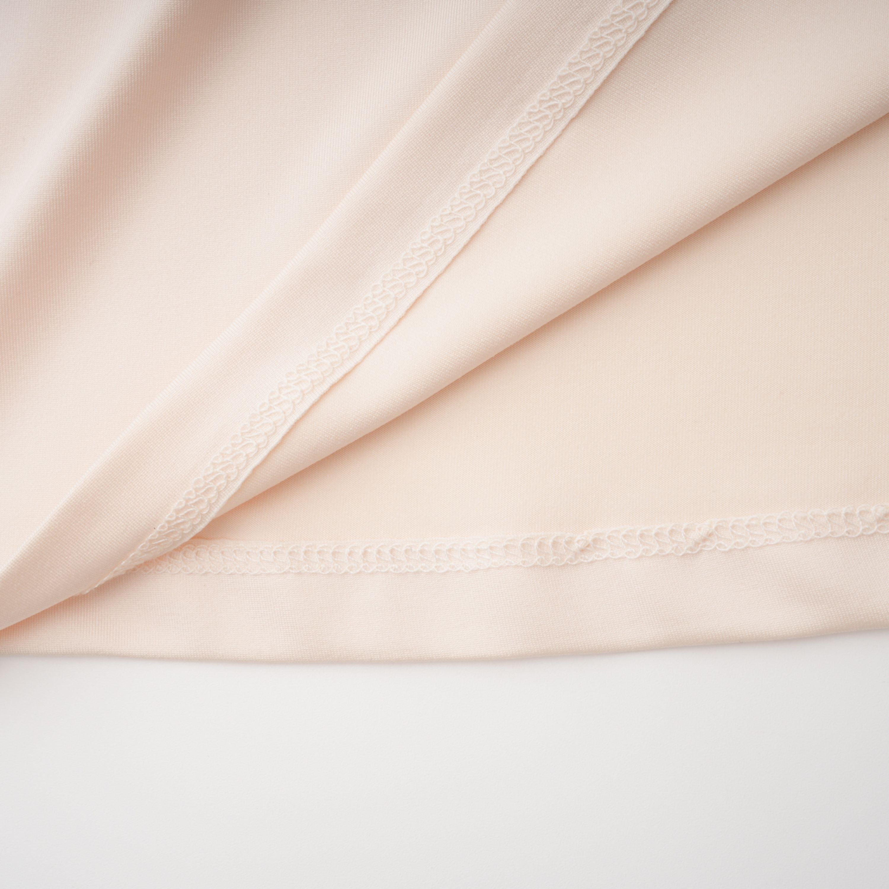 Cream halter maxi dress with waist cutouts and a knotted draped bodice