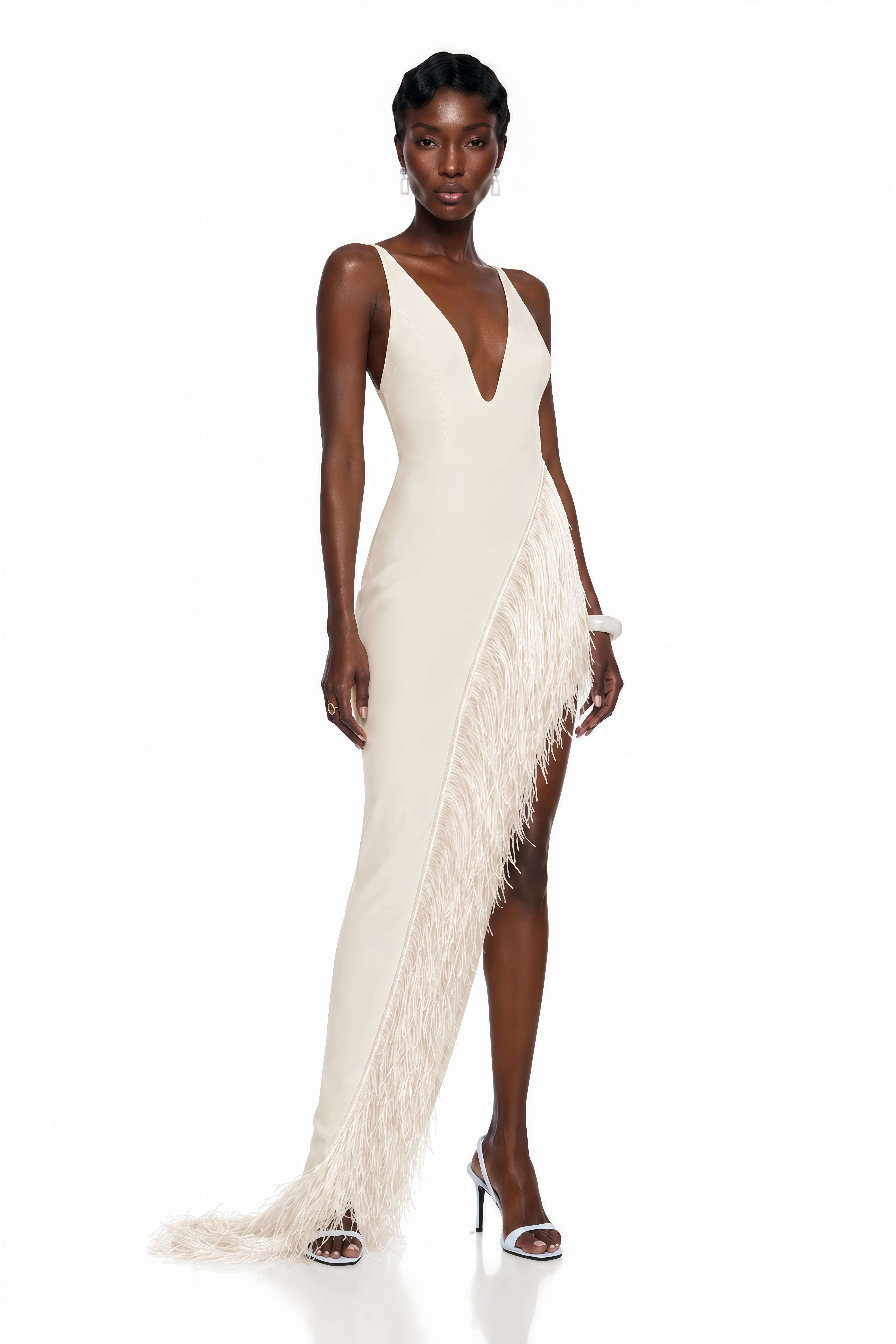 White maxi dress with a plunging V-neckline and a high slit trimmed with fringe
