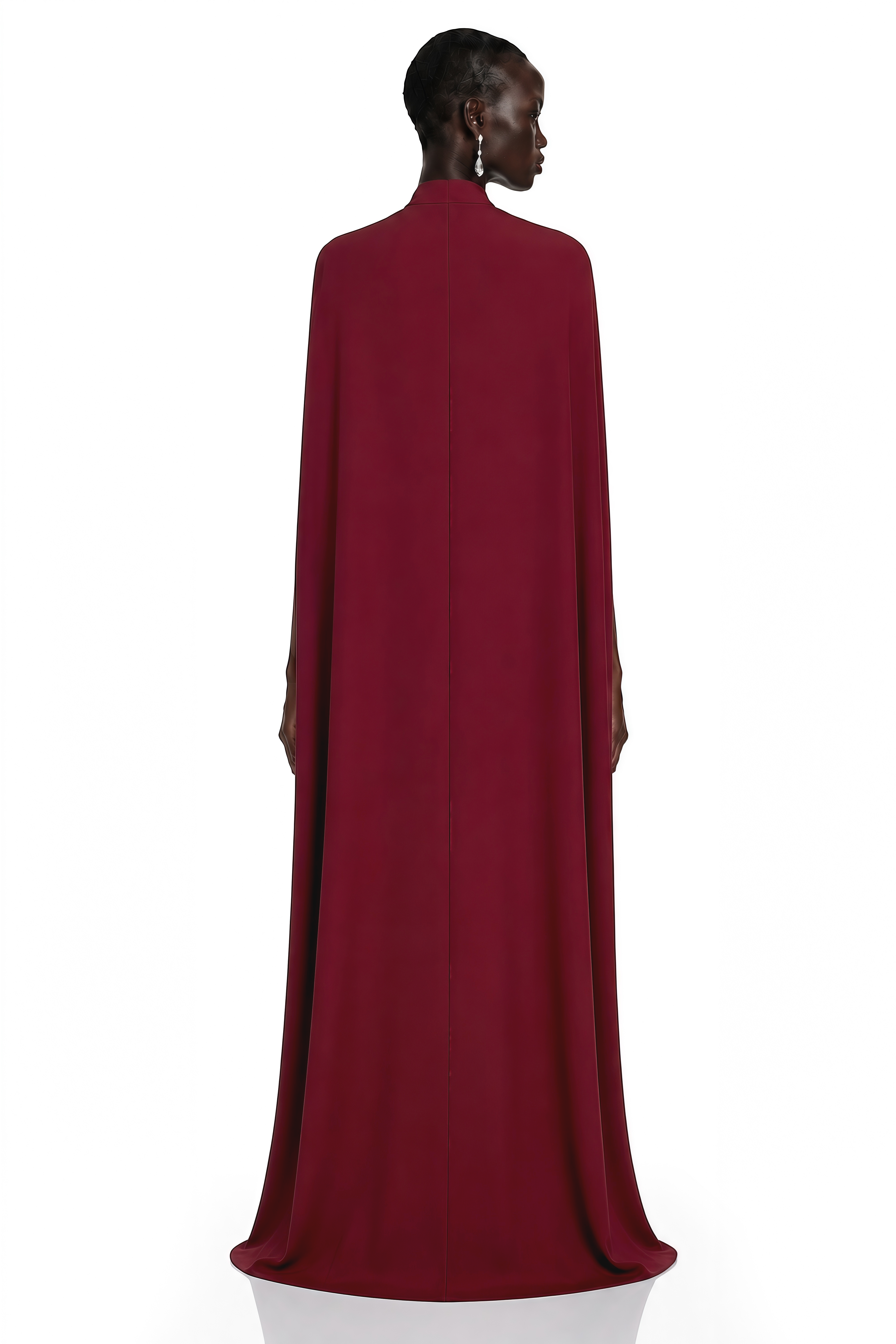 Burgundy high-neck maxi dress with long sleeves and an asymmetric floor-length cape overlay