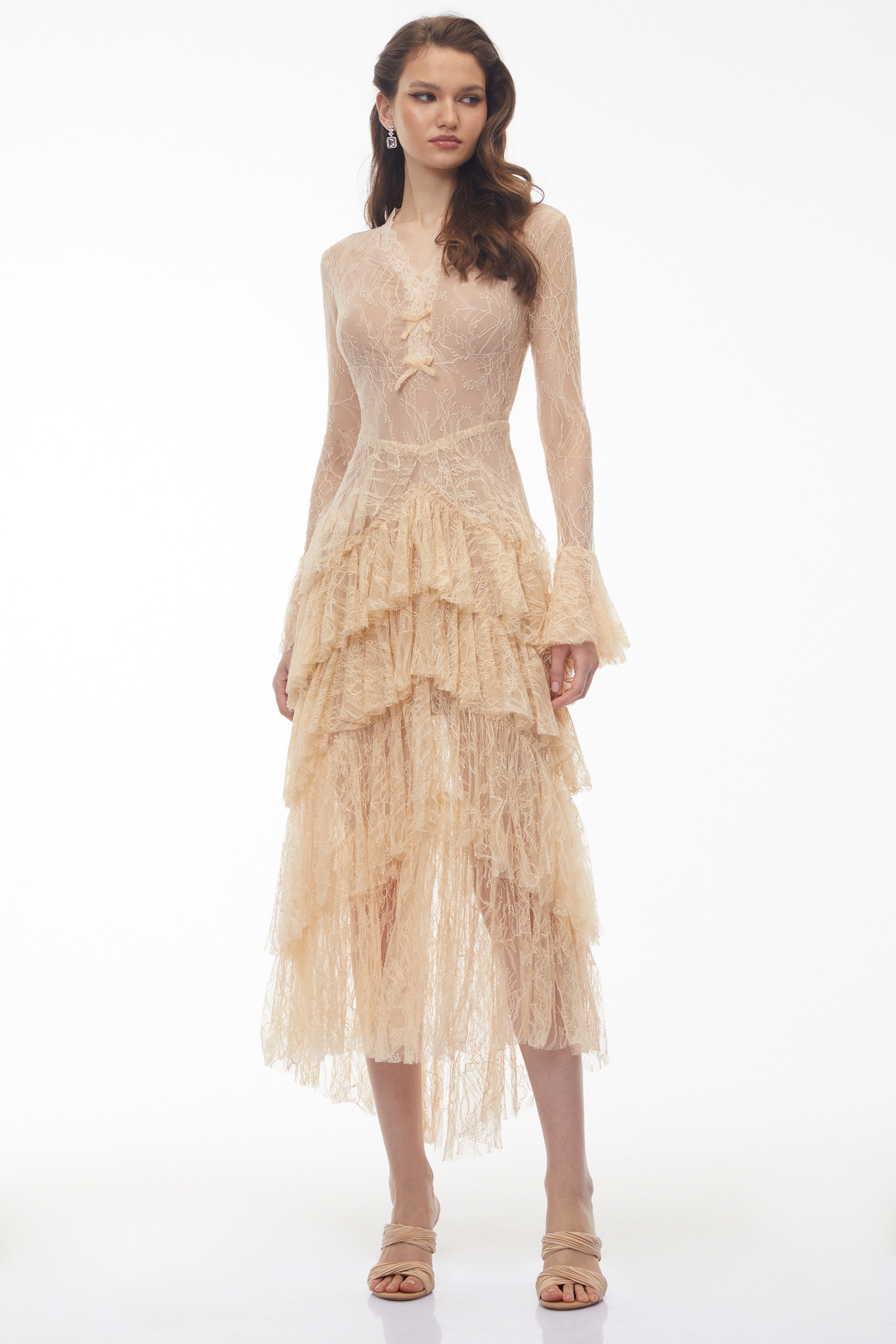 Beige lace gown with a tiered ruffled skirt