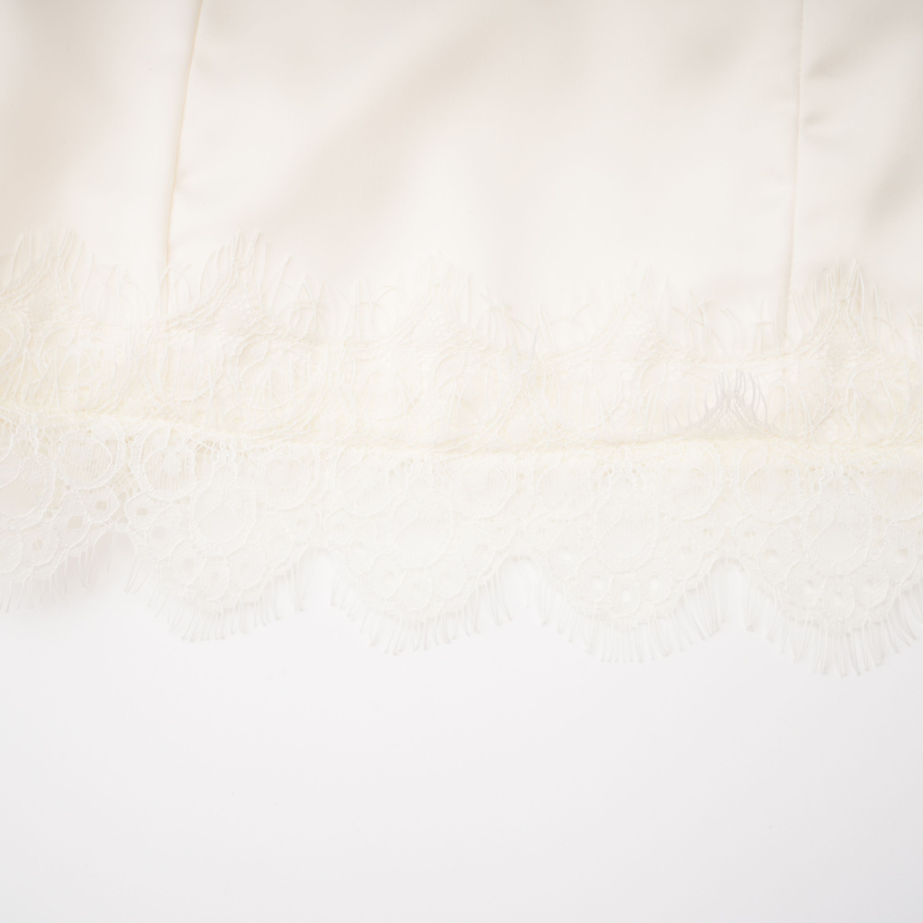 White satin corset mini dress with lace inserts and trim