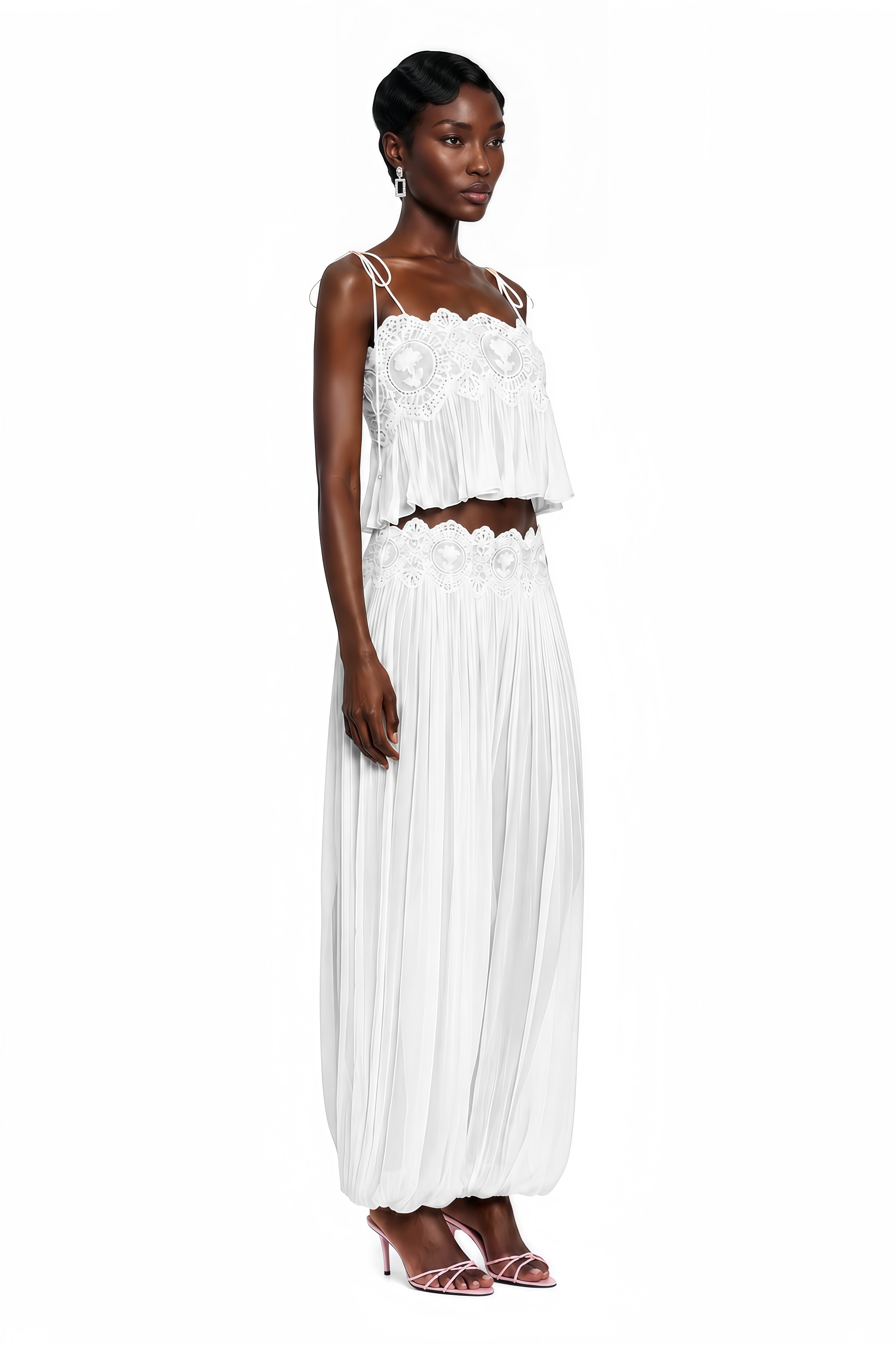 White two-piece set with a lace camisole crop top and matching pleated pants