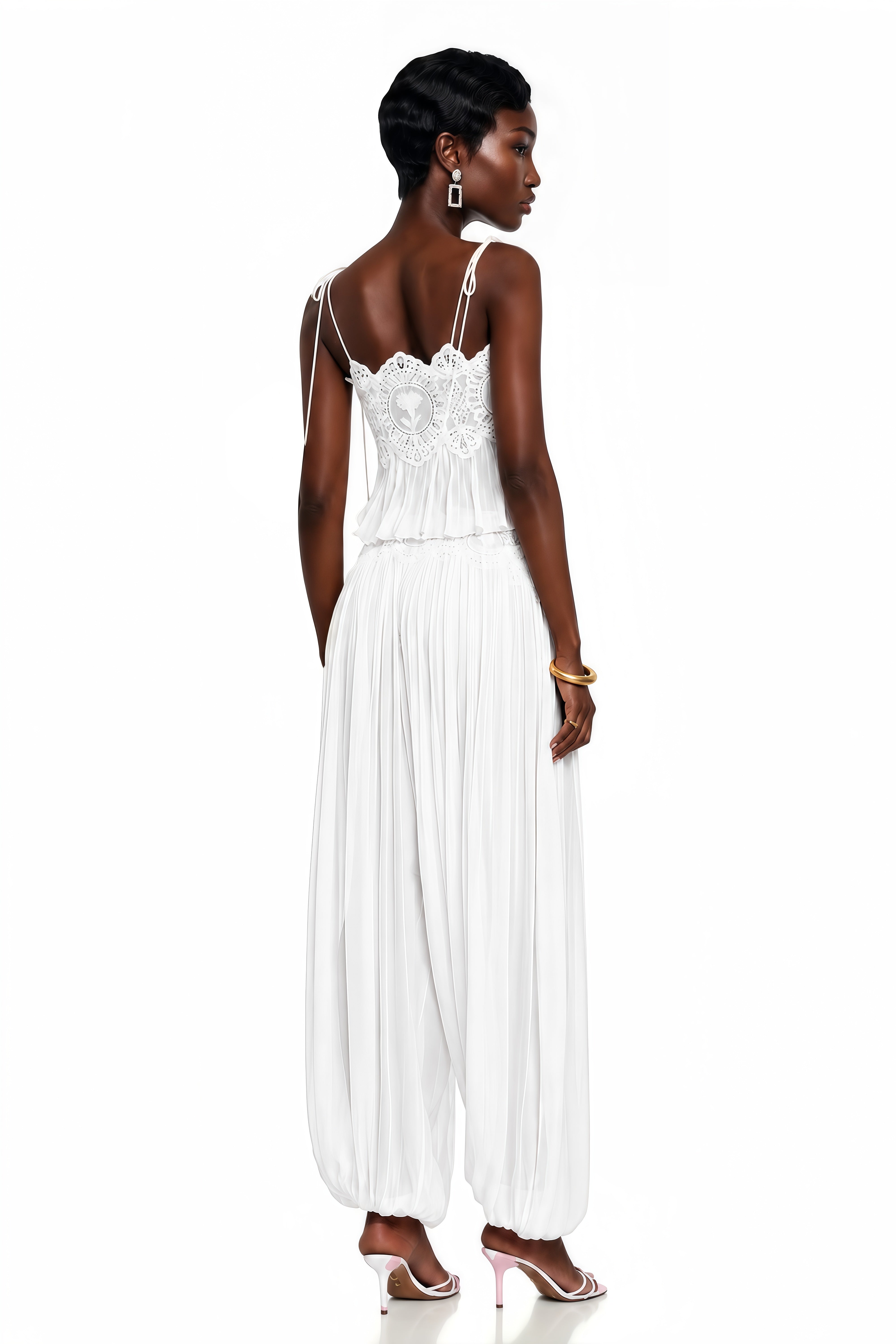 White two-piece set with a lace camisole crop top and matching pleated pants