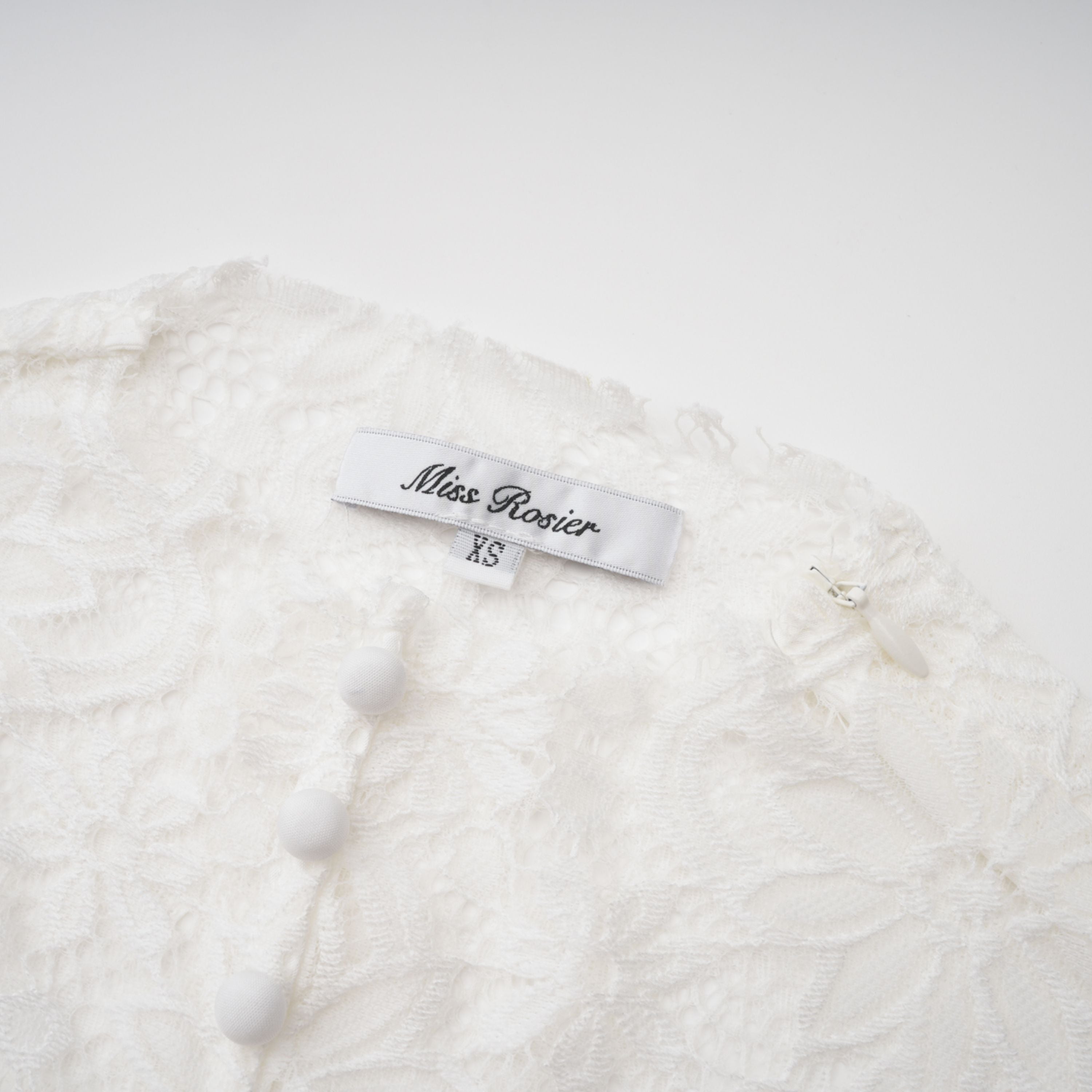 Black long-sleeve maxi dress with a sheer lace bodice and a draped skirt