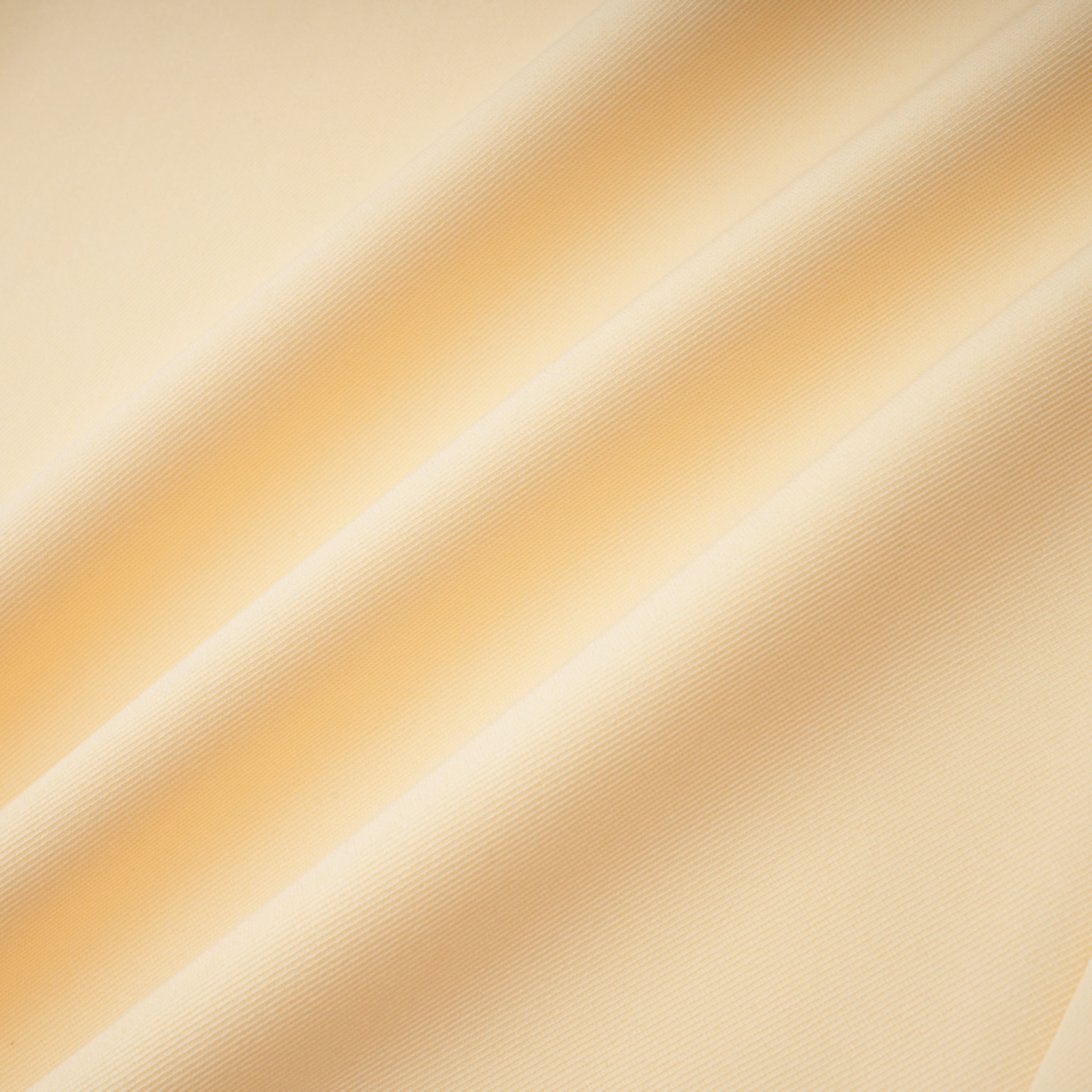 Pale yellow top and trousers set with an asymmetric blazer bodice, draped sheer neckline, and cape panels