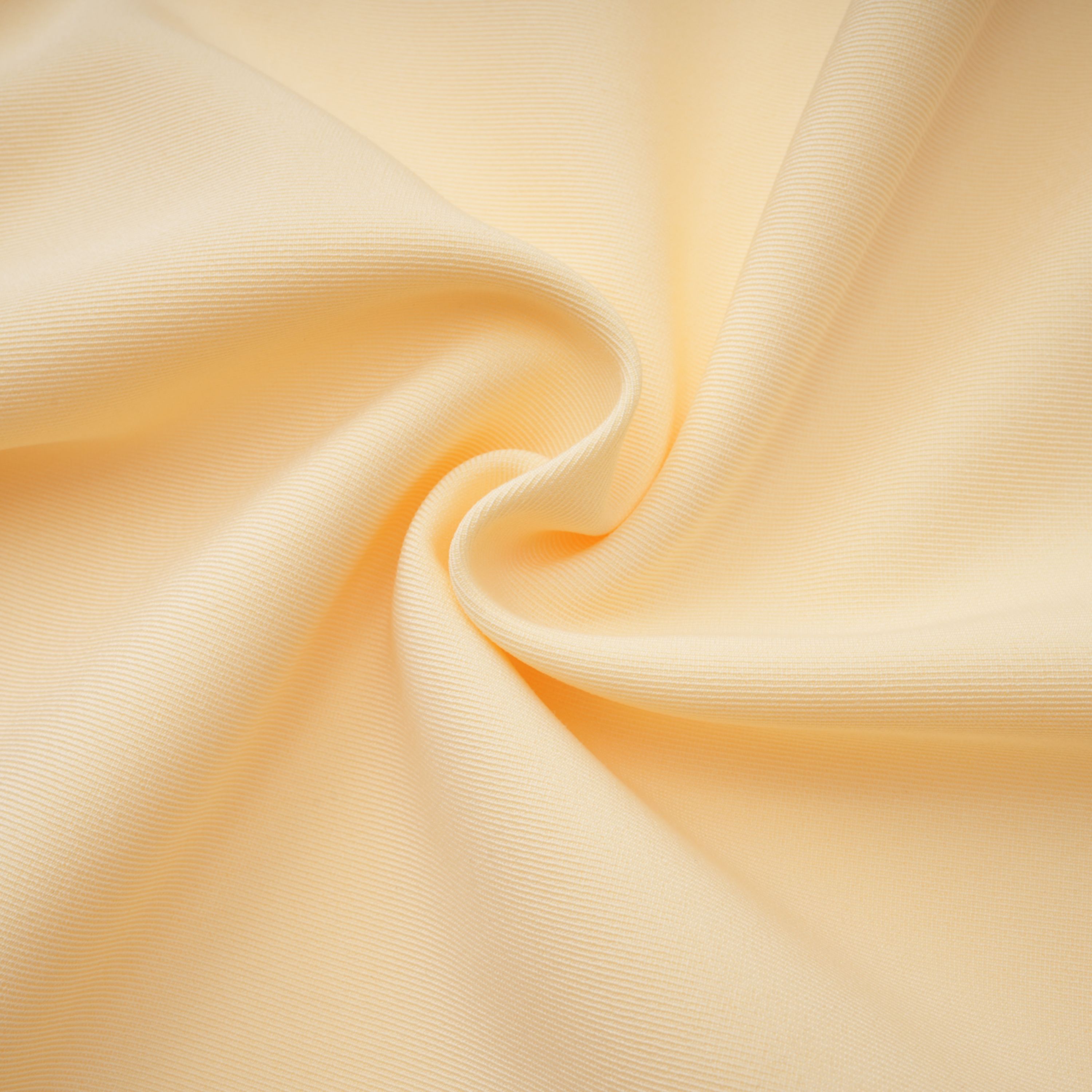 Pale yellow top and trousers set with an asymmetric blazer bodice, draped sheer neckline, and cape panels