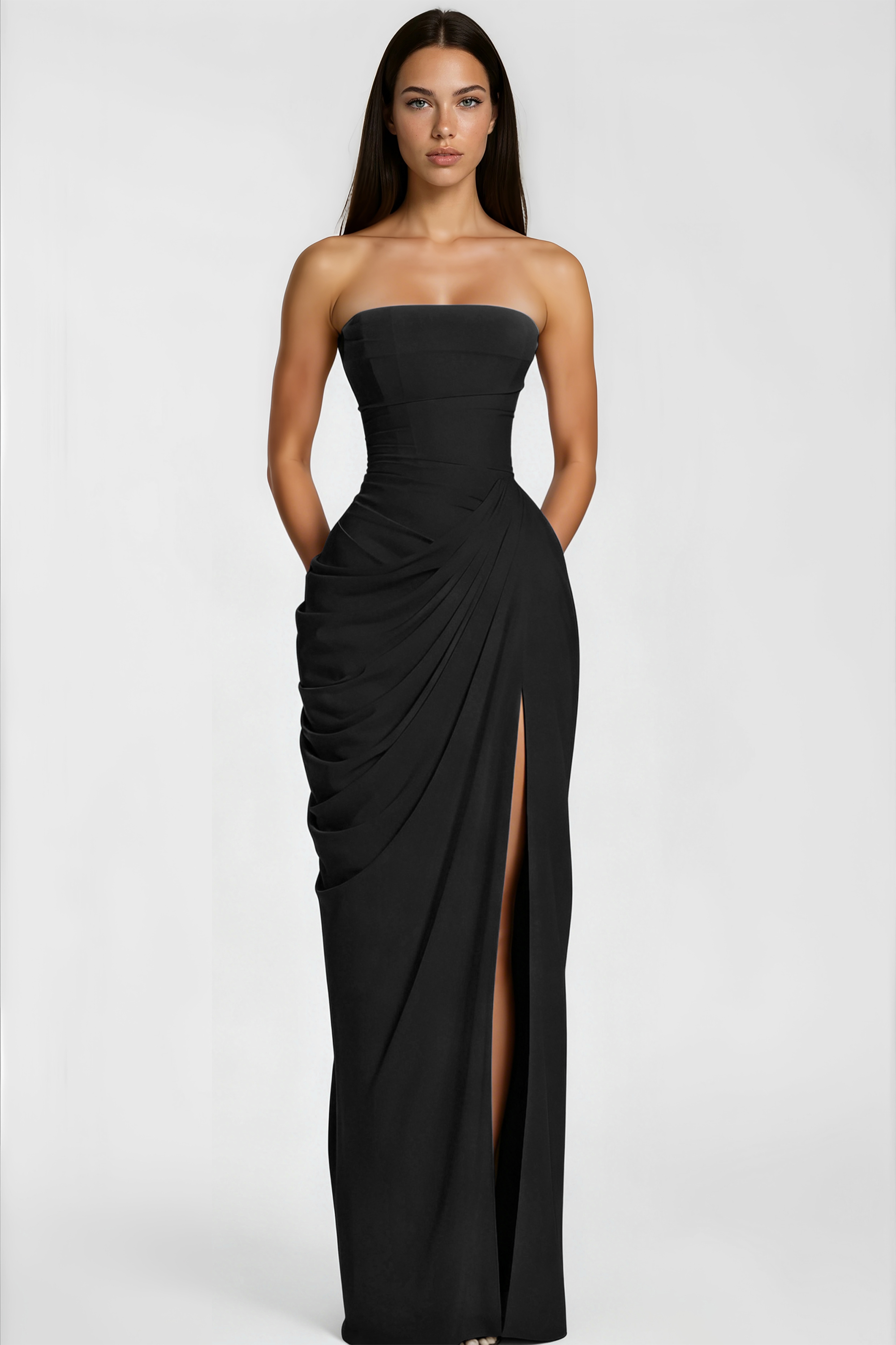 Black strapless maxi dress with a structured corset bodice, draped asymmetric skirt, and high leg slit