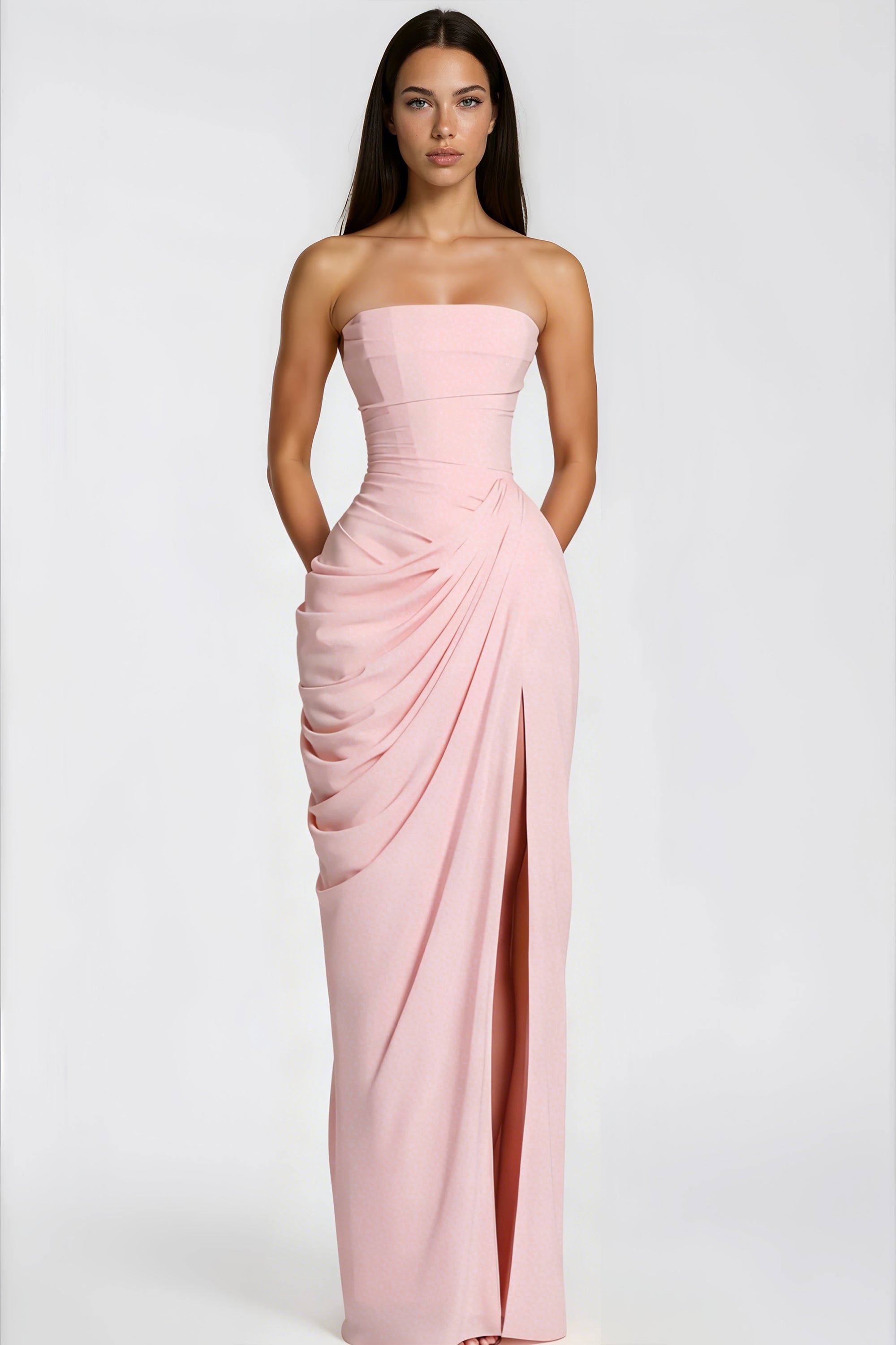 Pink strapless column gown with a draped waist and high thigh-slit