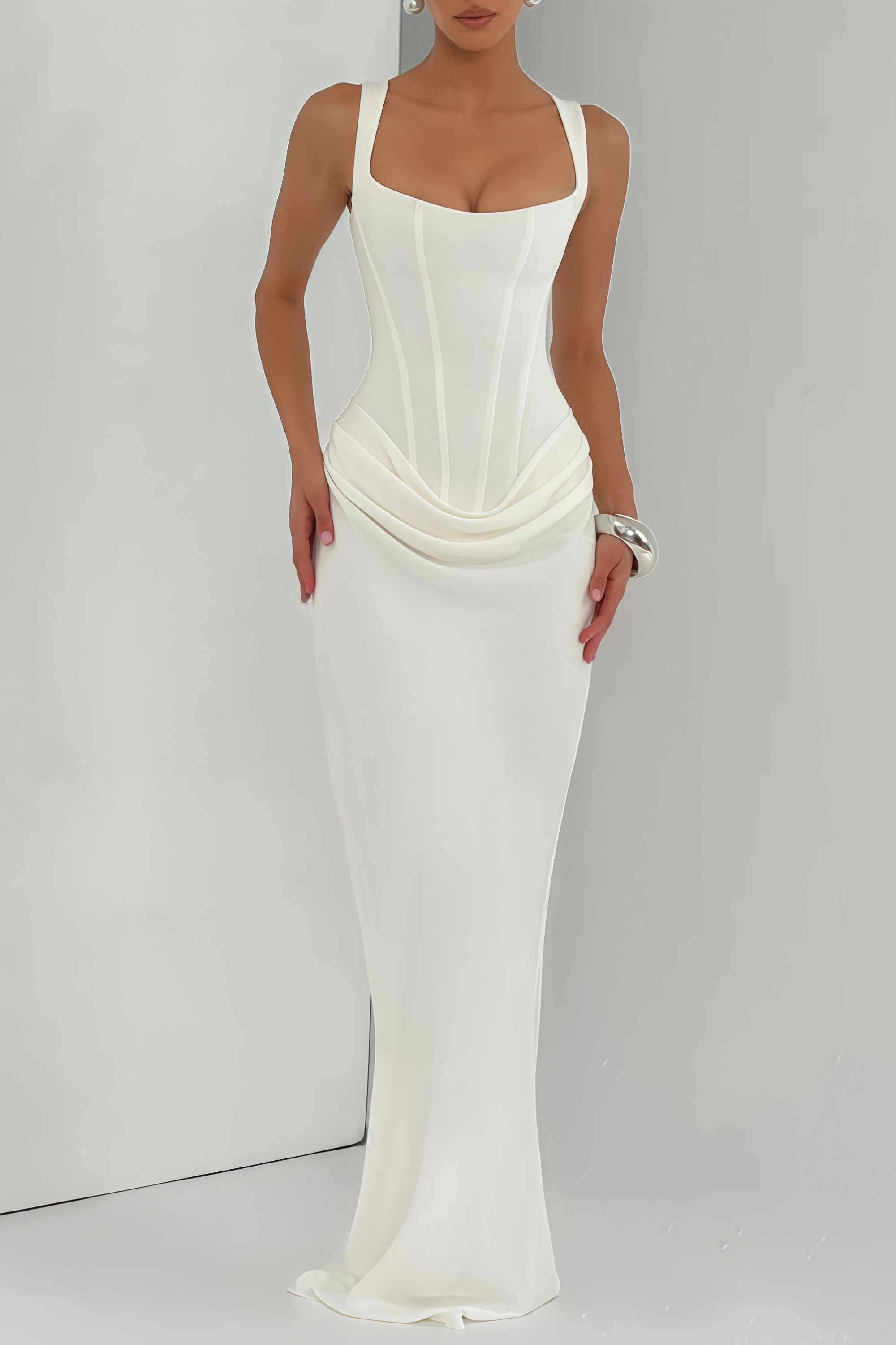 White sleeveless maxi dress with a corset-style bodice and draped hip detailing