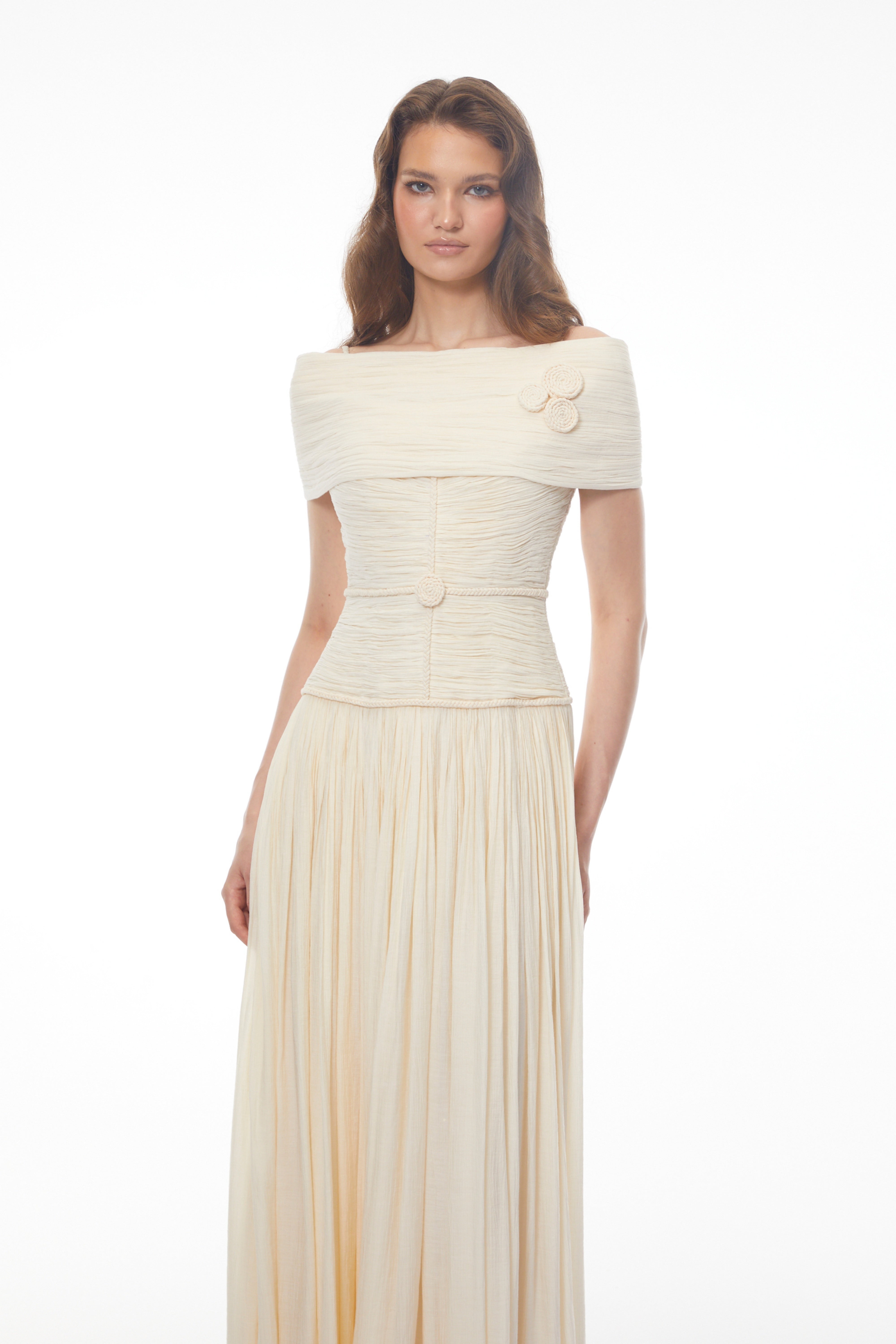 Black strapless maxi dress with a sheer lace corset waist, high leg slit, and a draped skirt