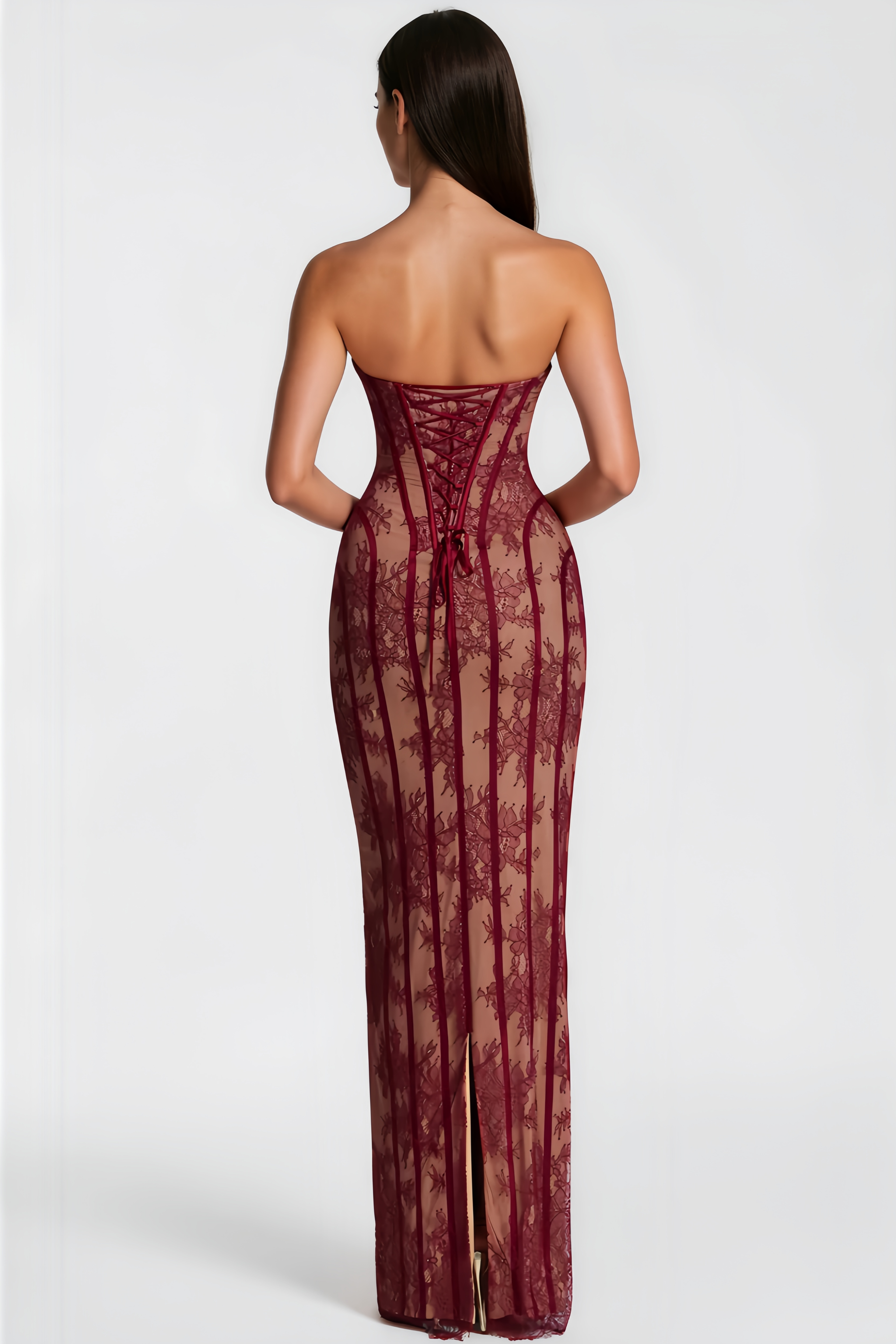 Burgundy strapless maxi dress featuring a nude lining with floral lace overlay and structured corset boning
