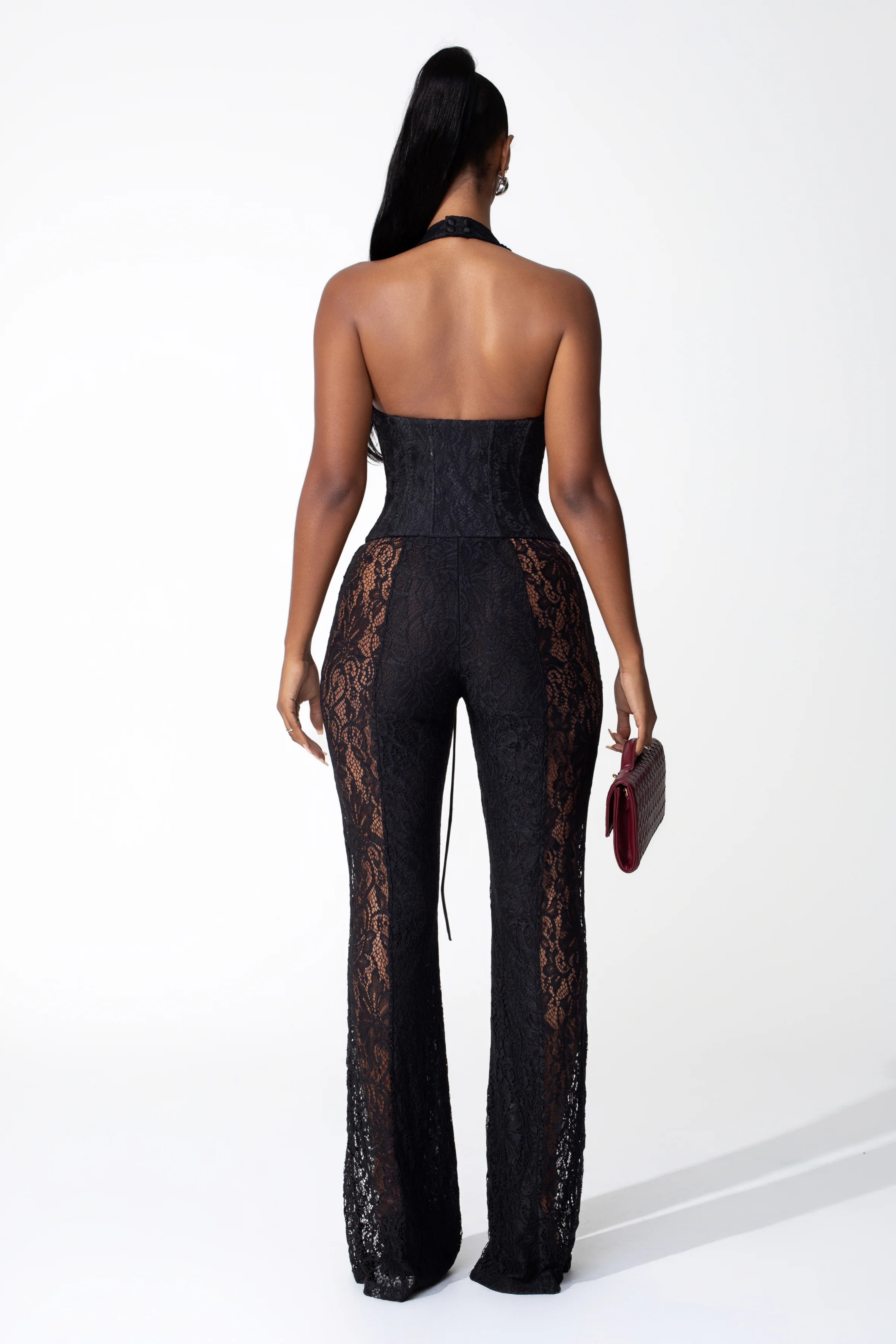 Lace halter jumpsuit with a corset-style lace-up bodice and flared legs