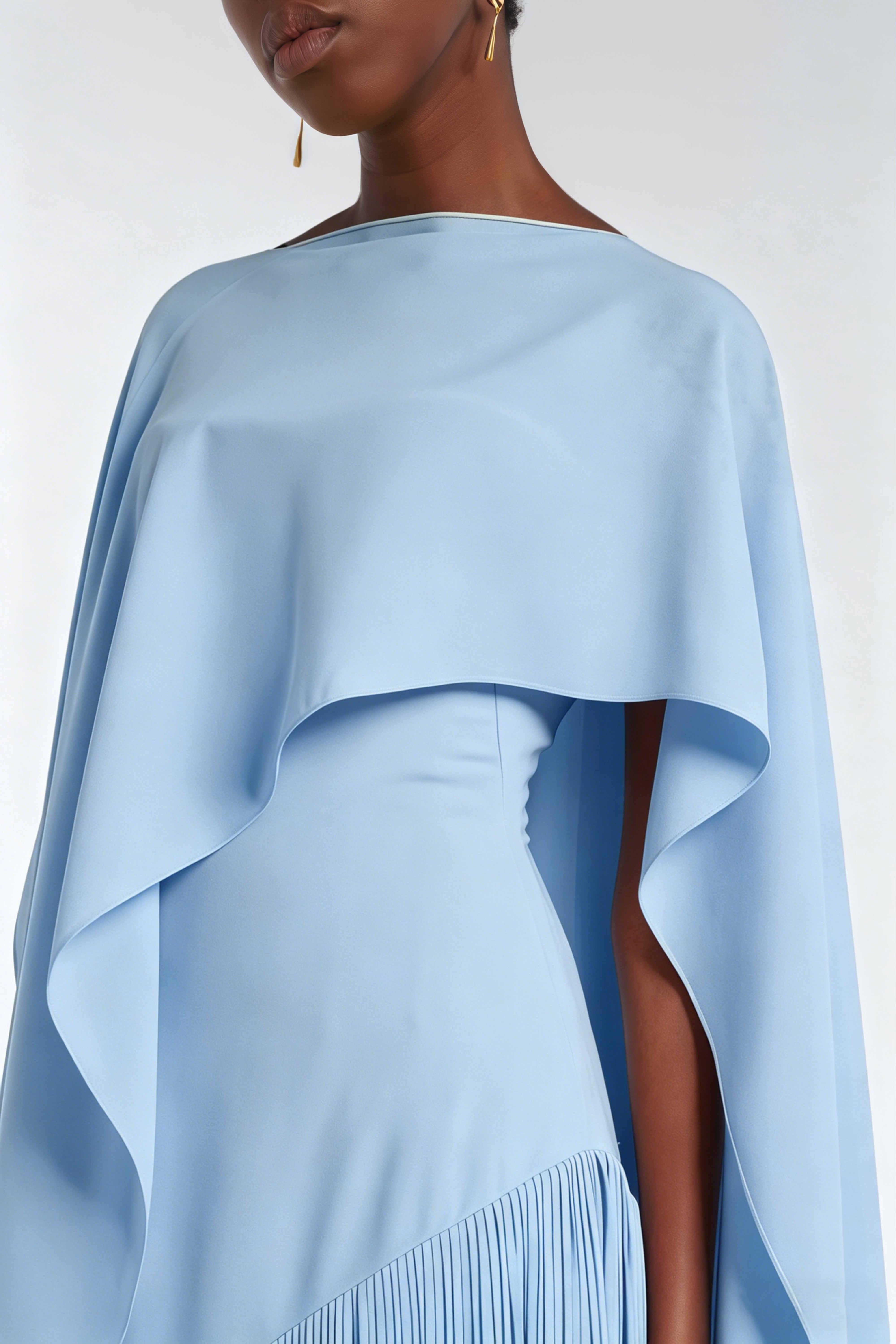 Light blue cape-style gown with a long fringed skirt