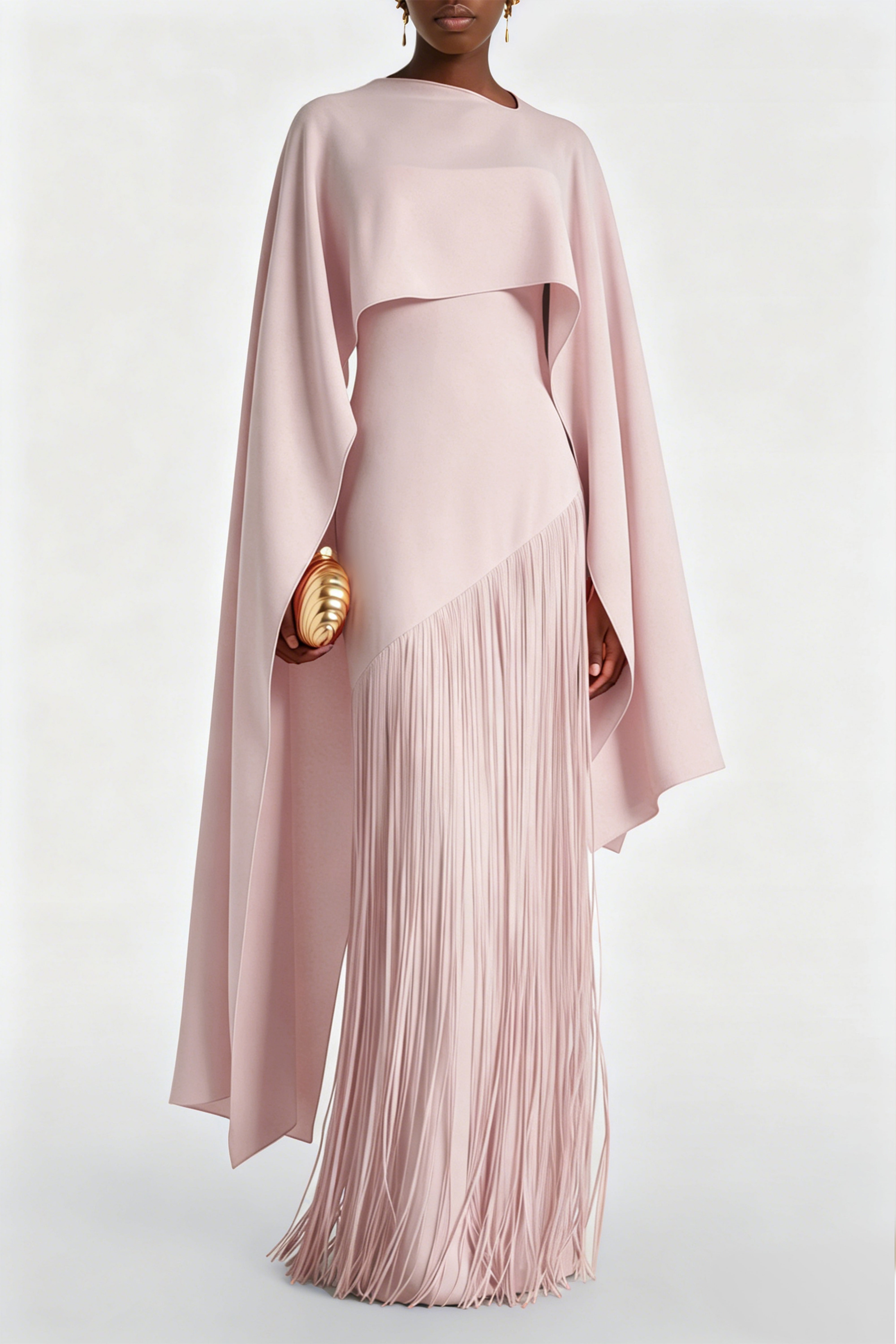 Light pink cape maxi dress with an asymmetrical waist and long fringe skirt