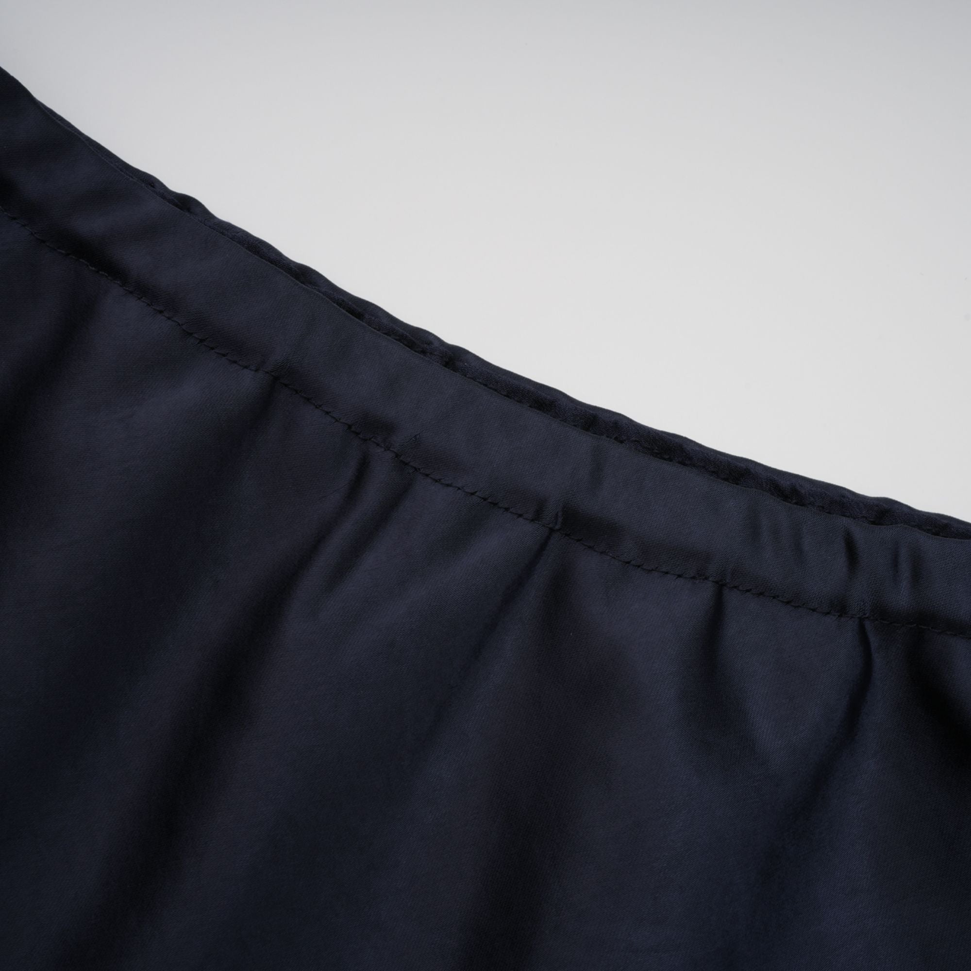 Navy blue short-sleeve maxi dress with a peplum jacket bodice and satin skirt