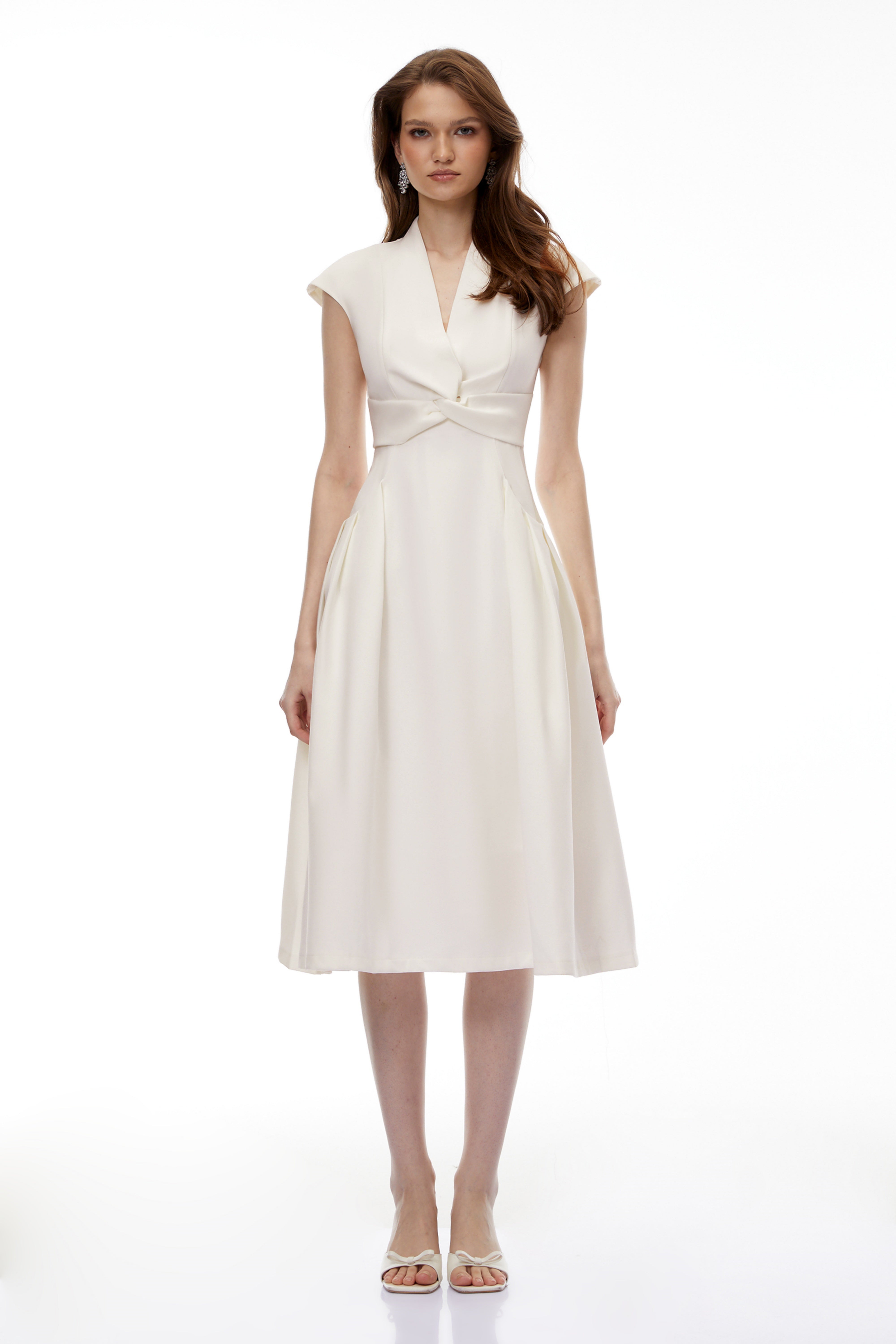 White midi dress with a surplice V-neckline, capped sleeves, and a structured A-line skirt
