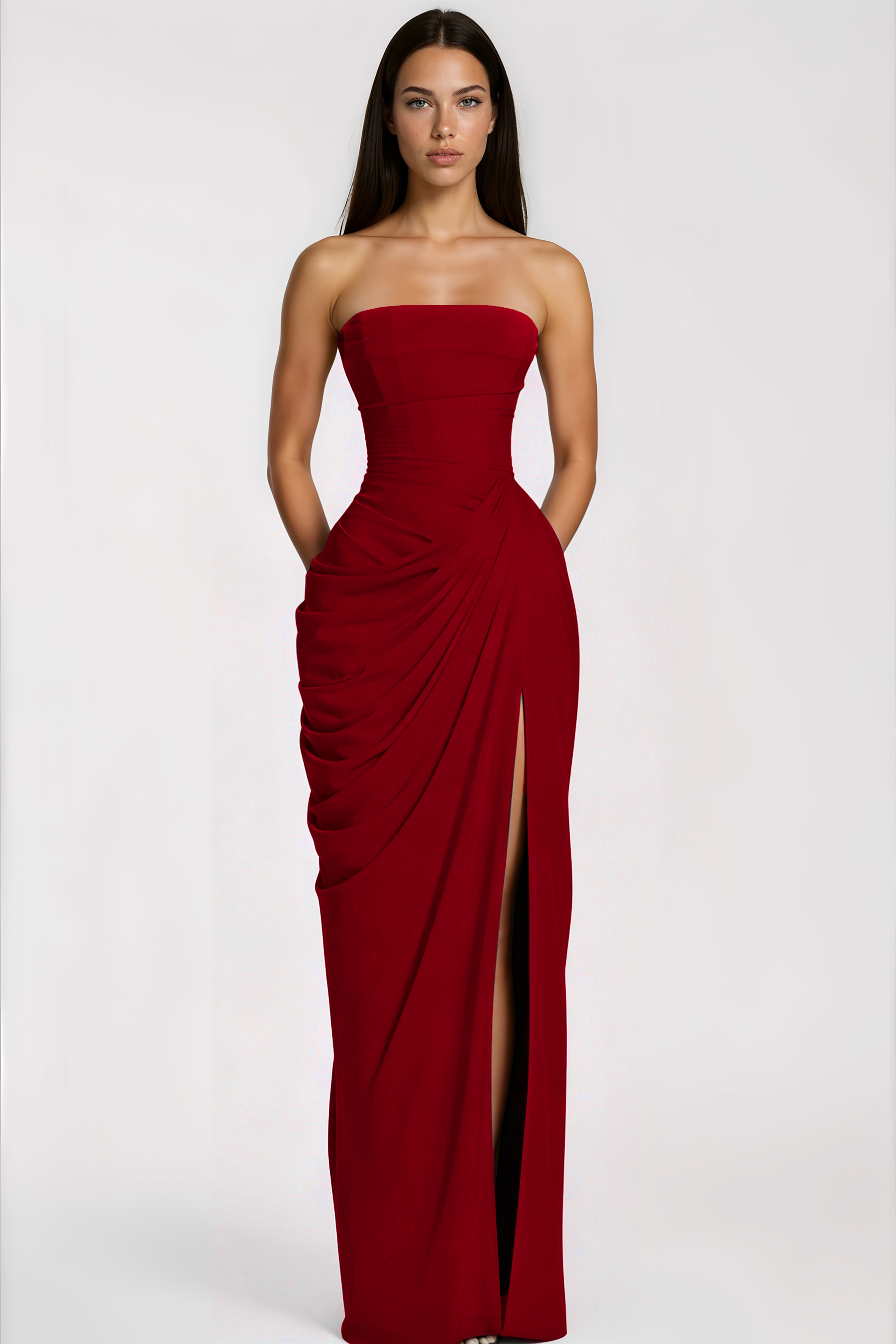 Red strapless maxi dress with a fitted bodice, a draped gathered hip, and a high thigh-high slit