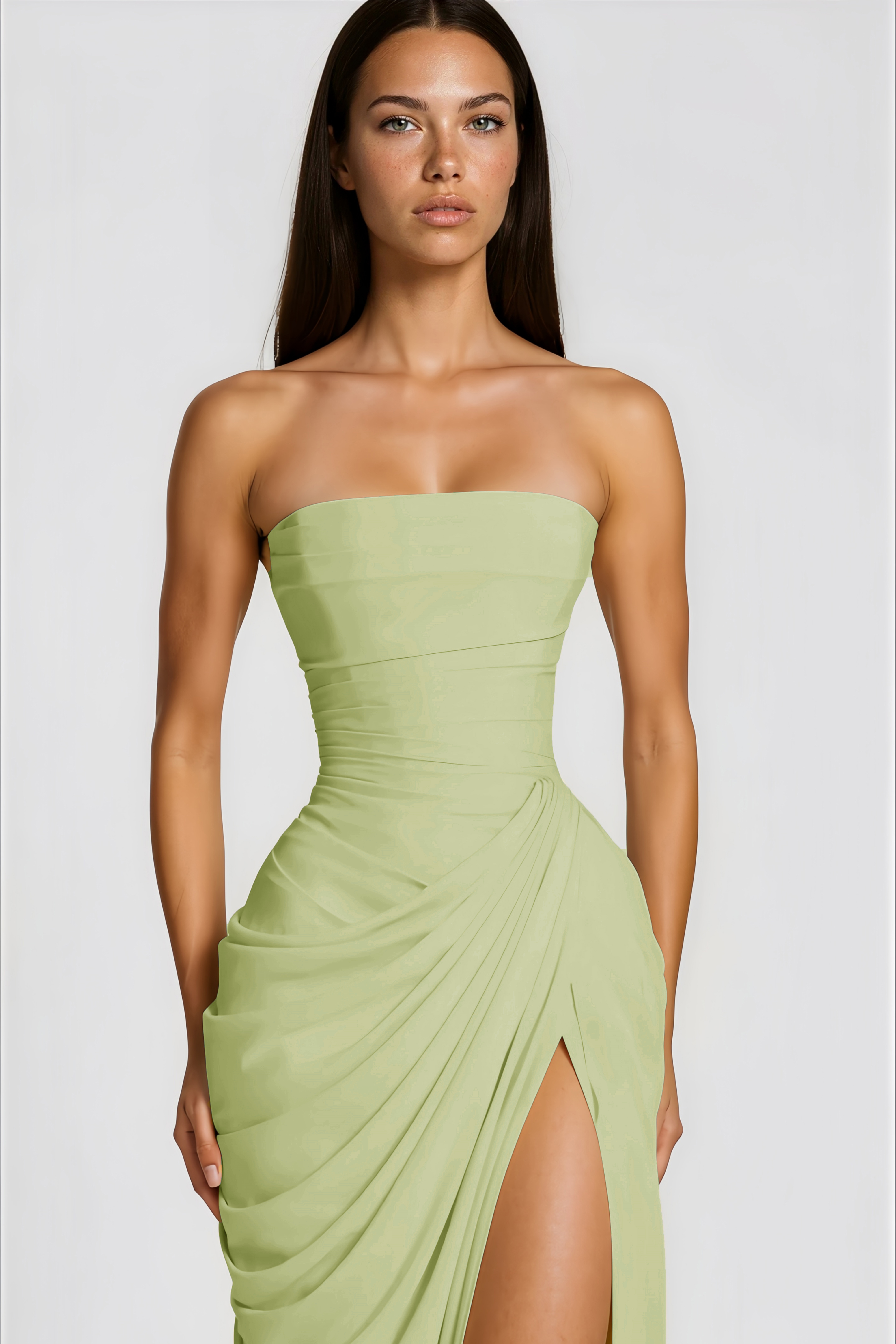 Sage green strapless maxi dress featuring a structured bodice and a draped wrap skirt with a high slit