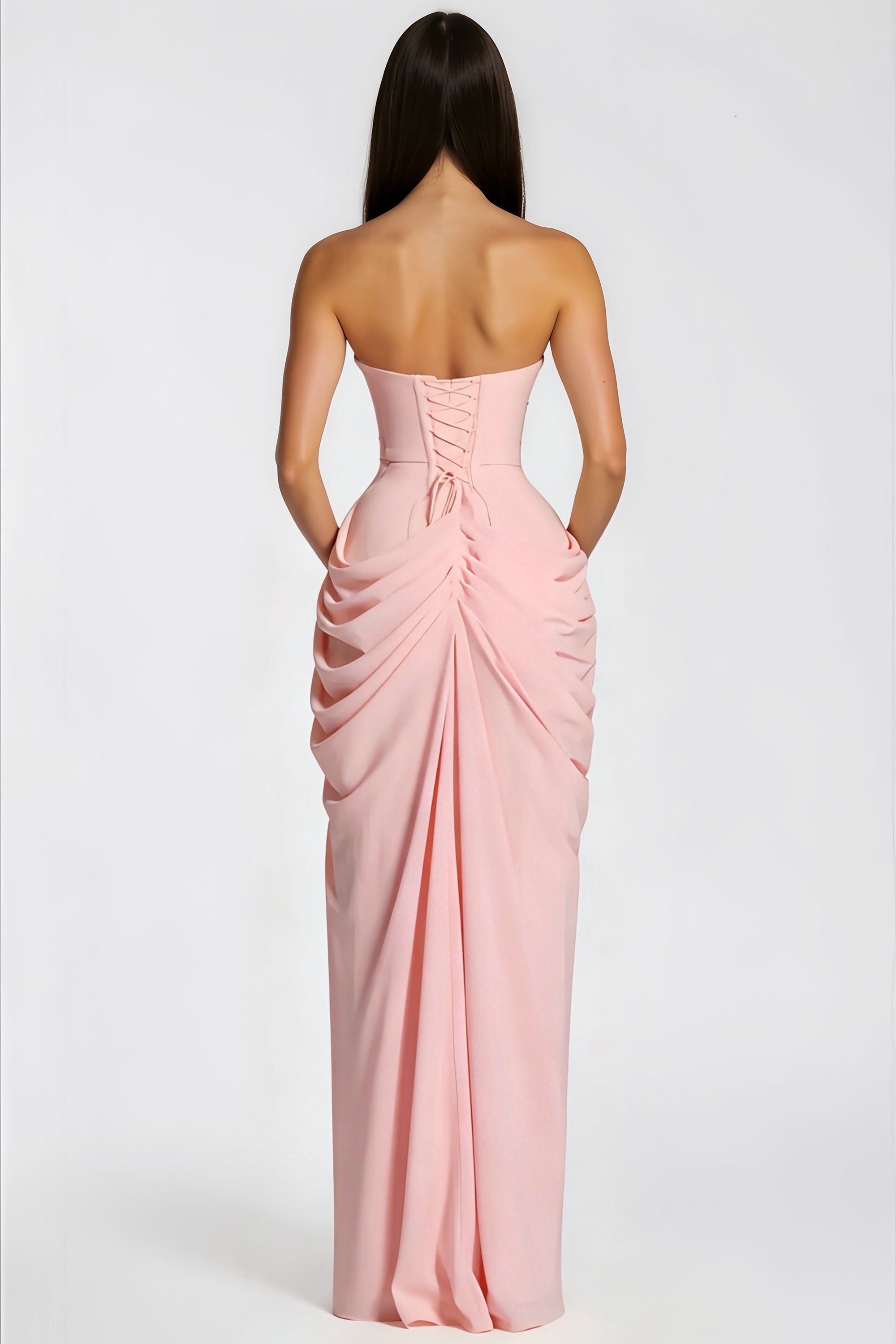Pink strapless column gown with a draped waist and high thigh-slit