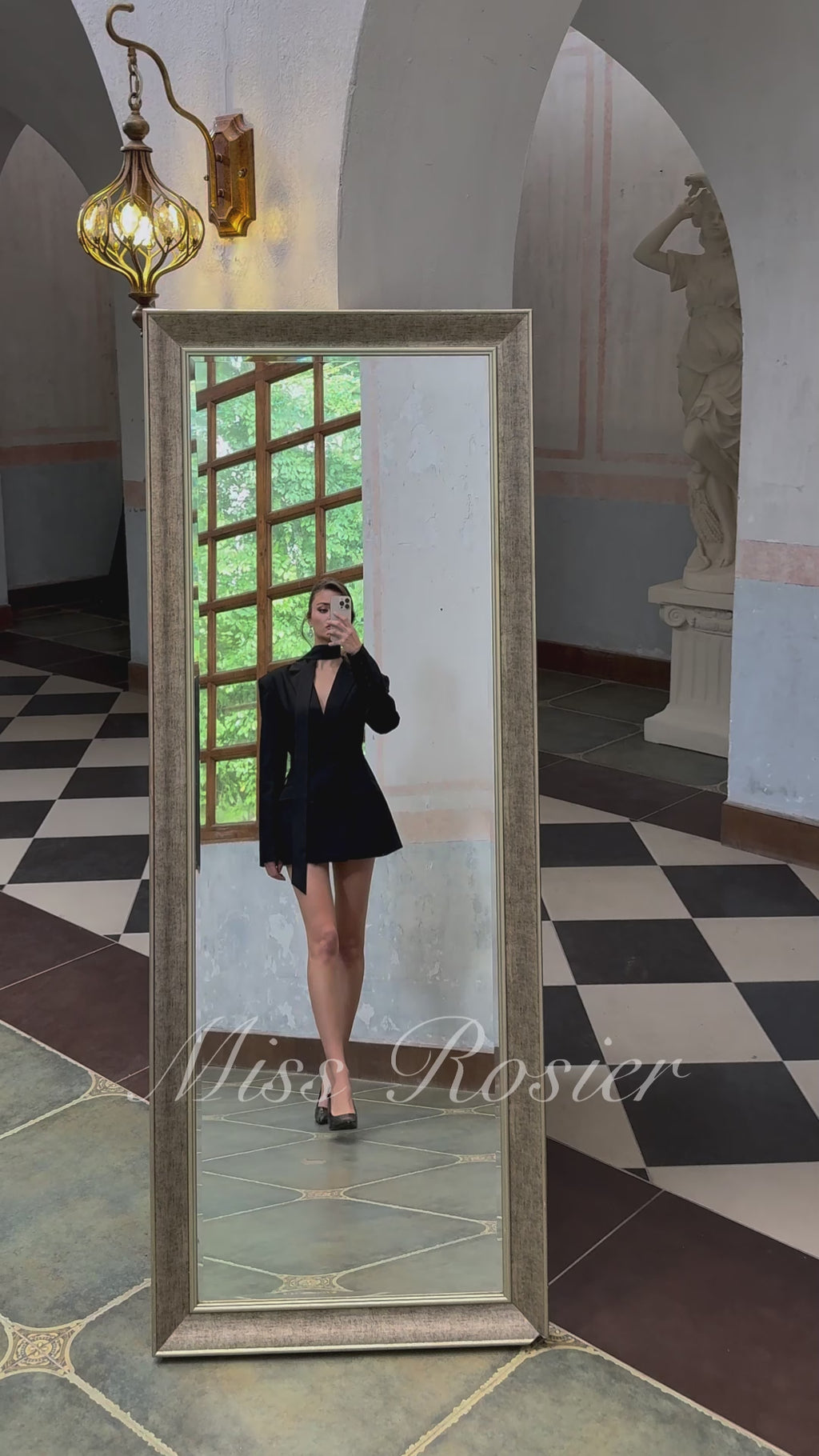 Black double-breasted blazer dress with structured shoulders and a matching neck tie